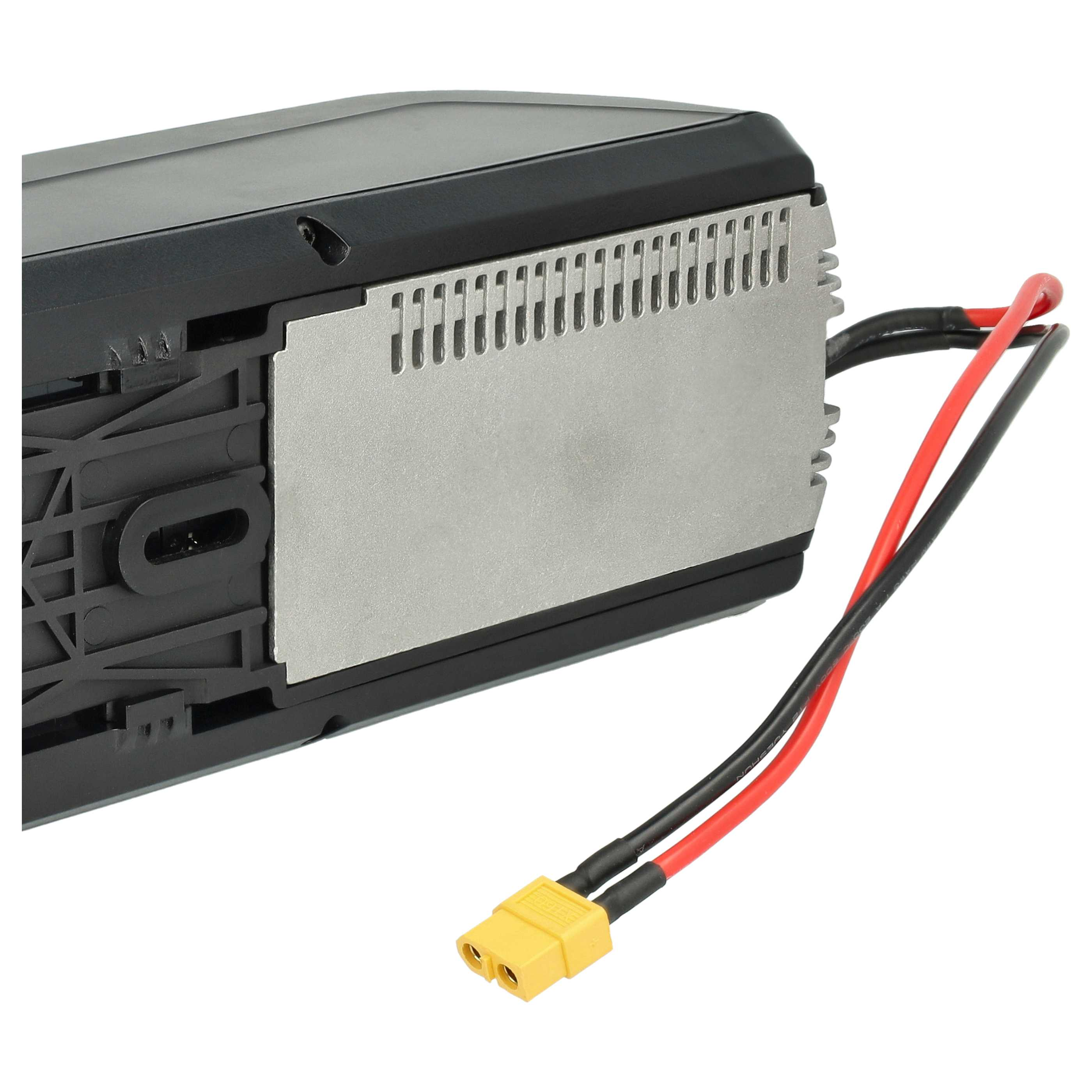Ein schwarzes und silbernes elektronisches Gerät mit roten und schwarzen Drähten und einem gelben Stecker. Weißer Hintergrund.