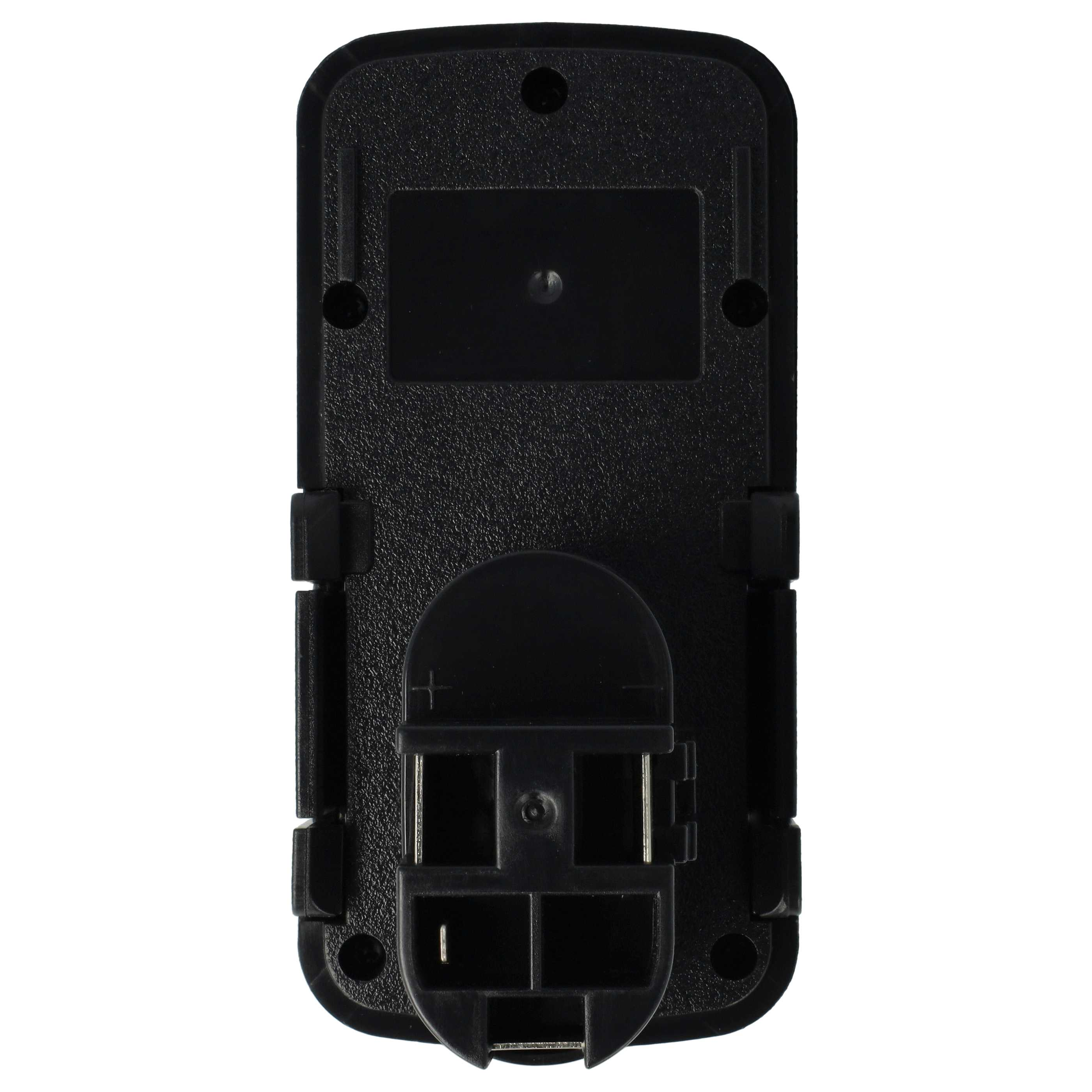 Ein schwarzes Kunststoffobjekt, möglicherweise eine Batteriebasis, mit verschiedenen Formen, Öffnungen und Anschlusspunkten, vor weißem Hintergrund.