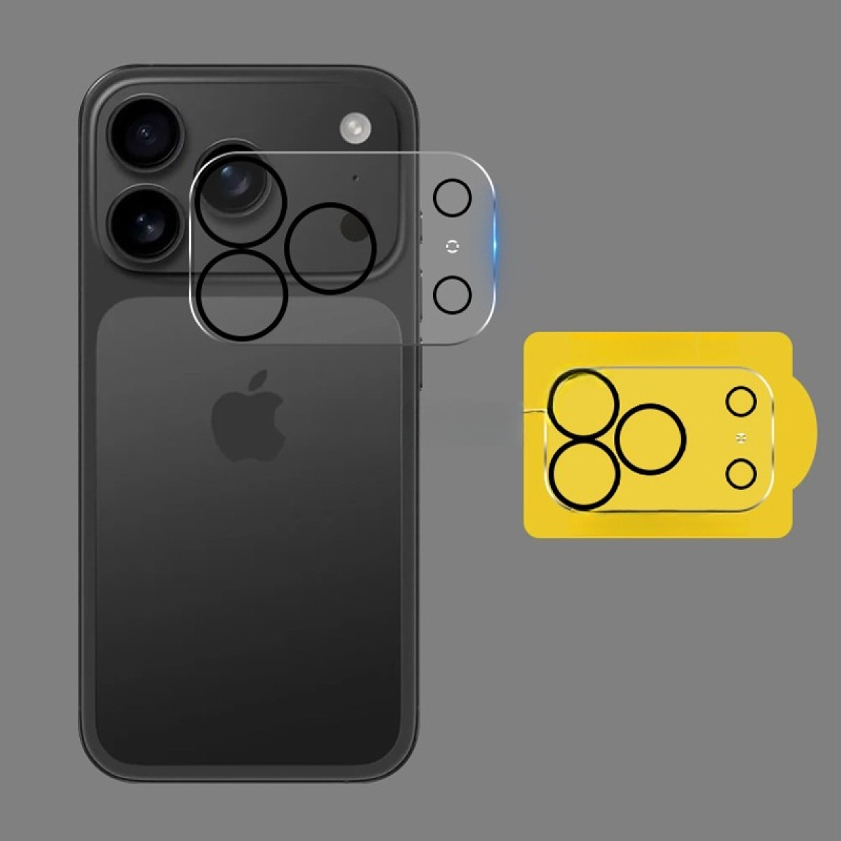 iPhone negro con protector de lente de cámara. Una herramienta amarilla está al lado del teléfono. Fondo gris.
