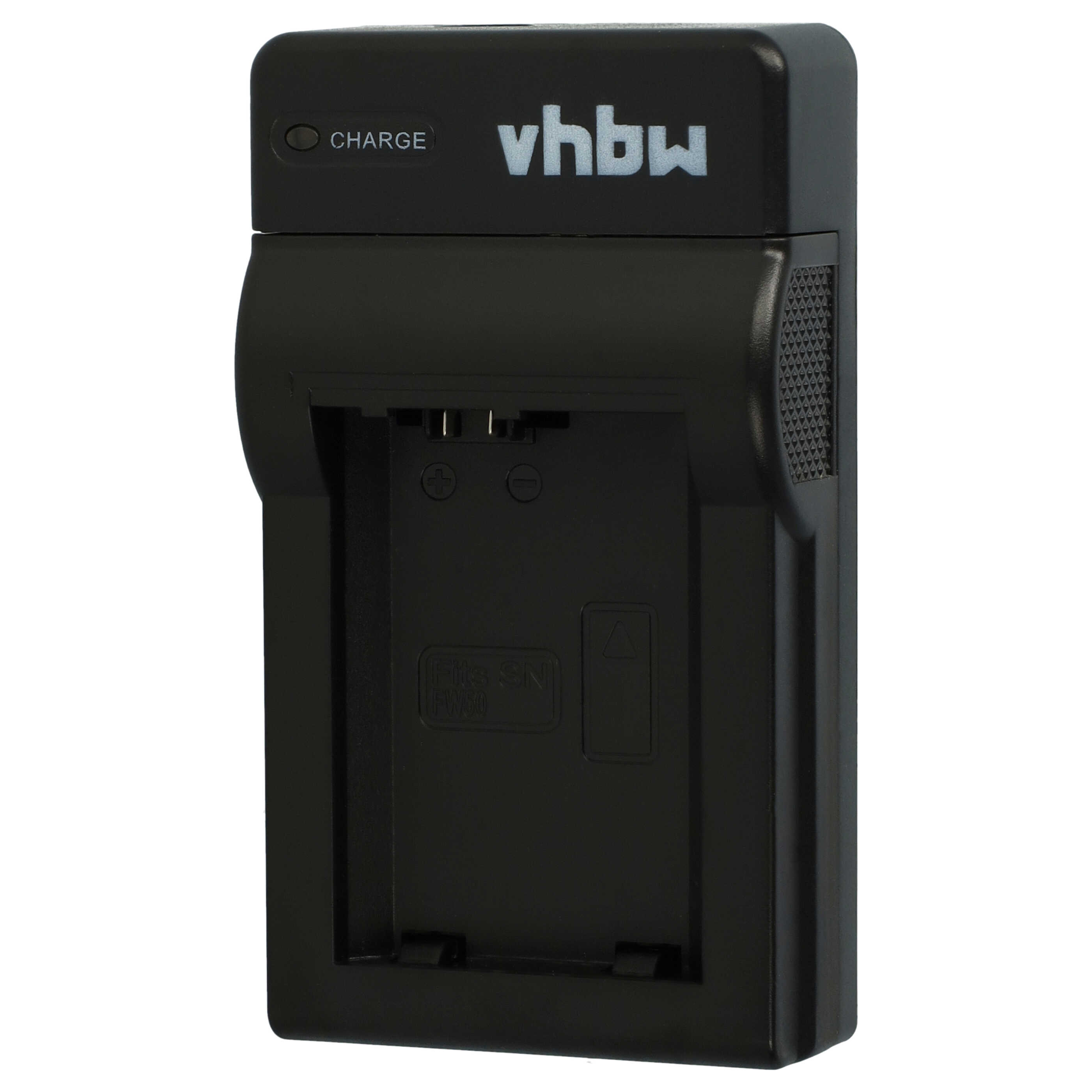 Schwarzes vhbw-Ladegerät. Hat eine Ladeanzeige. Vorderseite hat Schlitze für eine Batterie.