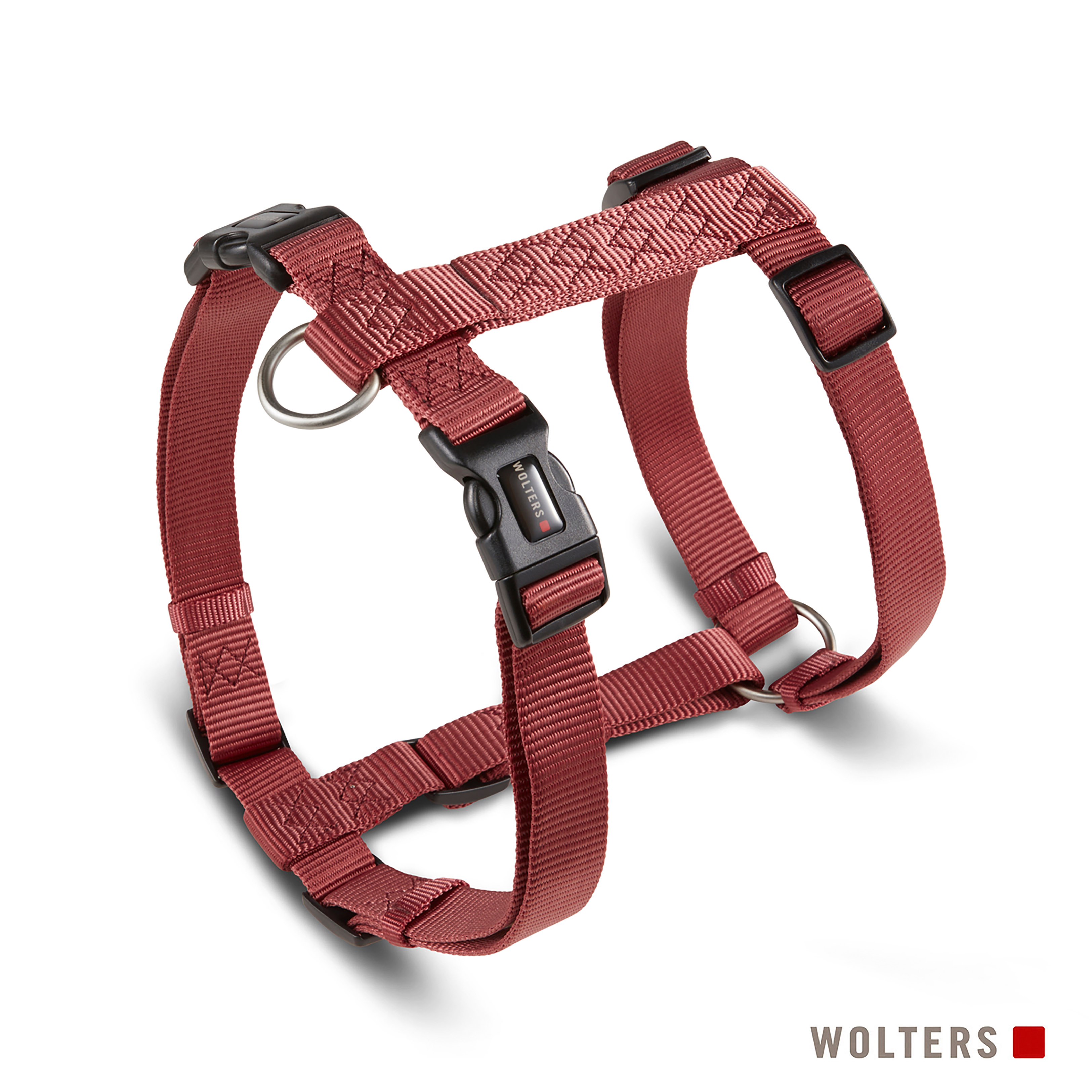 Ein rotes Hundegeschirr mit schwarzen Schnallen vor weißem Hintergrund. Der Markenname ist sichtbar.