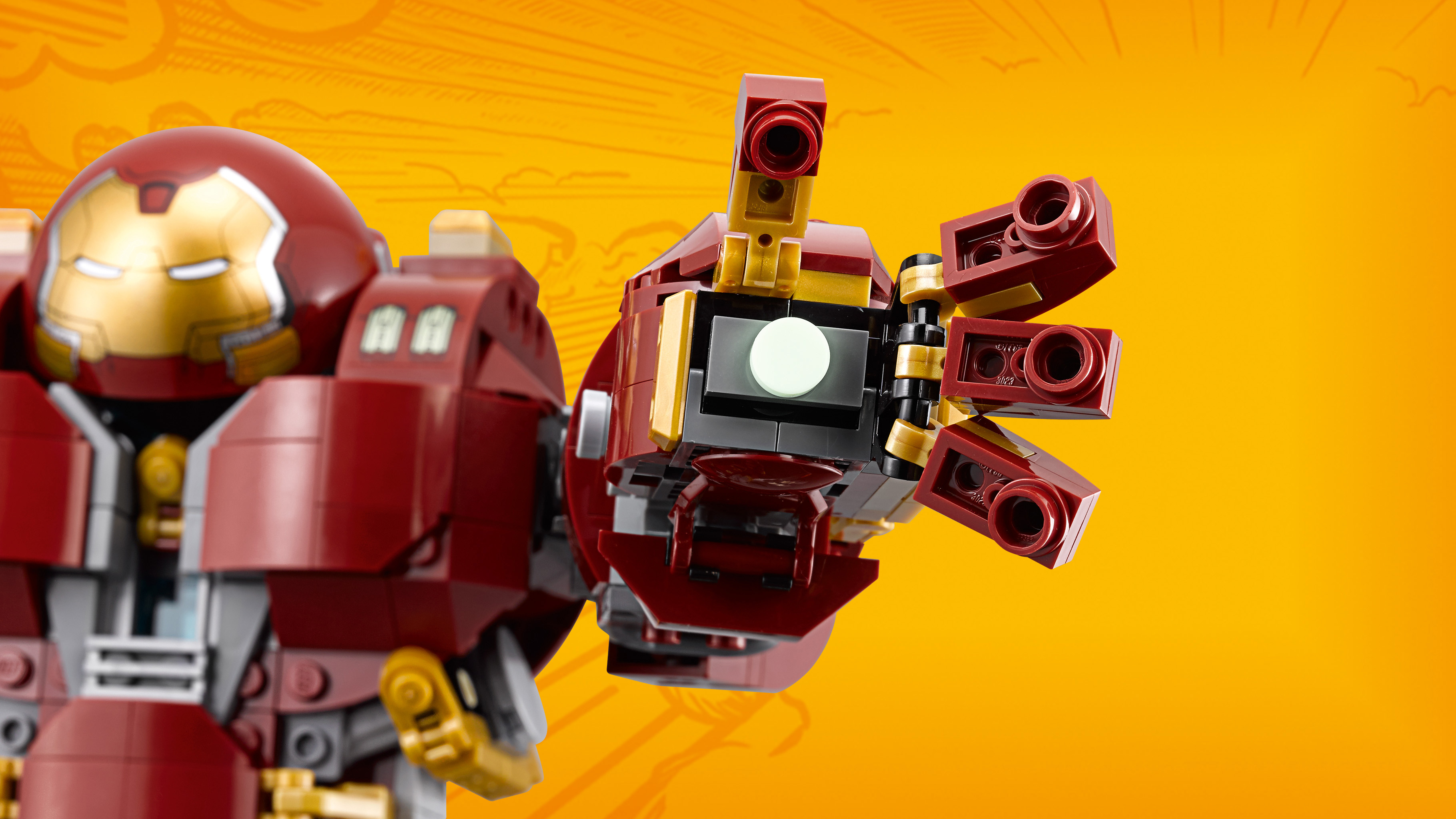 Hulkbuster Iron Mana z Lego. Czerwono-złota zbroja z wyciągniętą dłonią. Żółte tło z liniami w stylu komiksowym.