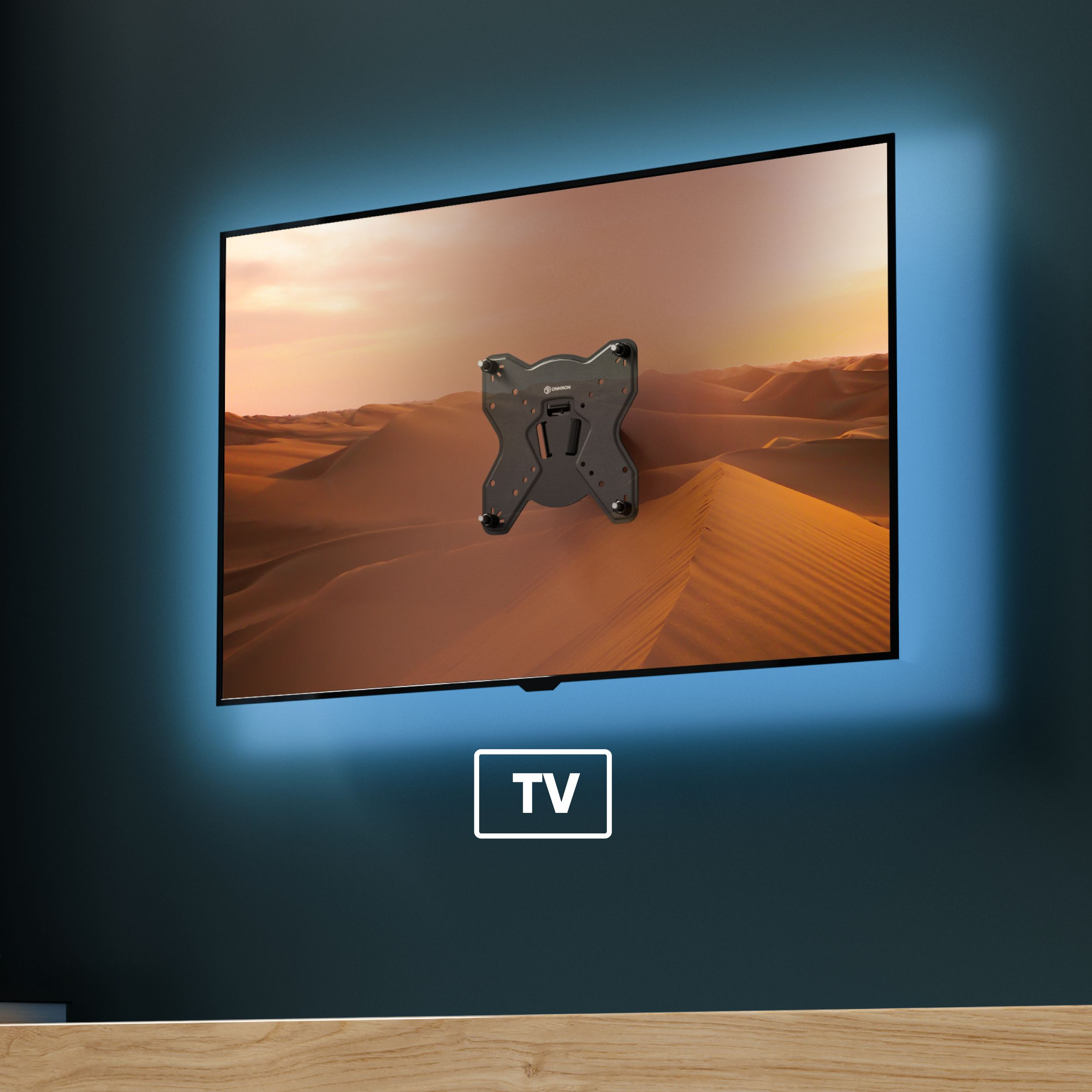 Telewizor zamontowany na ścianie. Ekran pokazuje pustynny krajobraz. Widoczny uchwyt TV.