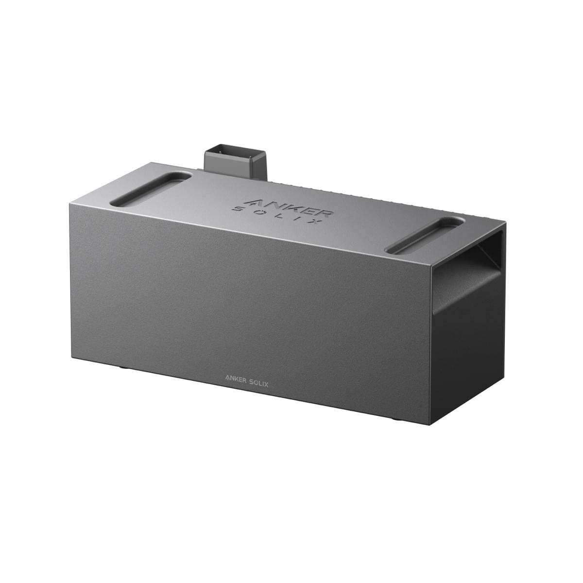 Un appareil gris Anker Solix. C'est une boîte rectangulaire avec un petit morceau rectangulaire au-dessus. Le nom de la marque est visible.
