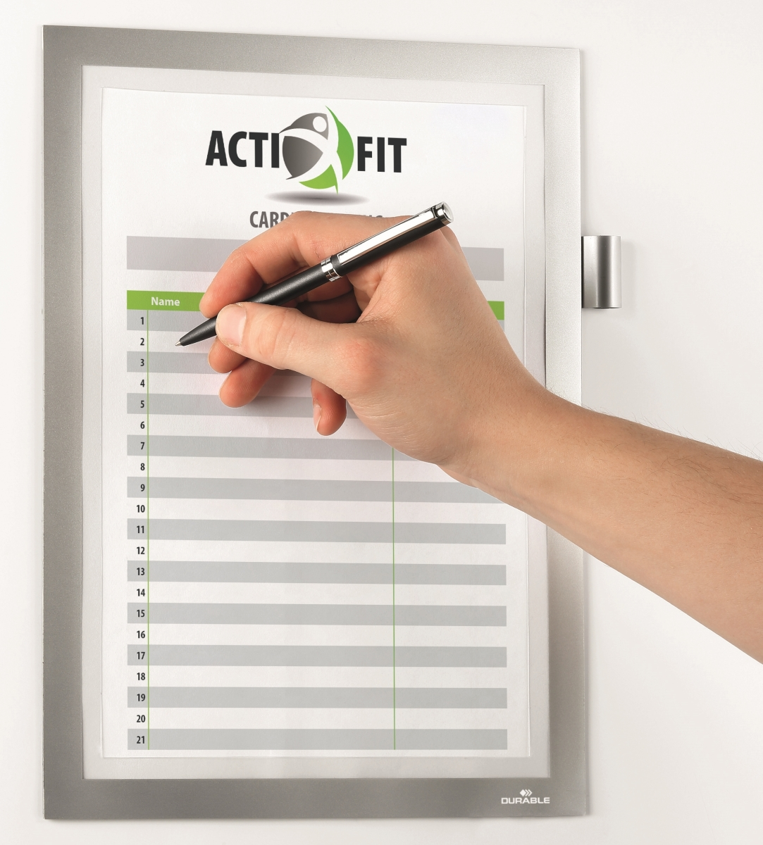 Eine Hand schreibt auf ein Formular. Das Formular befindet sich in einem Rahmen mit dem Logo ACTI FIT. Ein Stift wird über dem Abschnitt 'Name' gehalten.