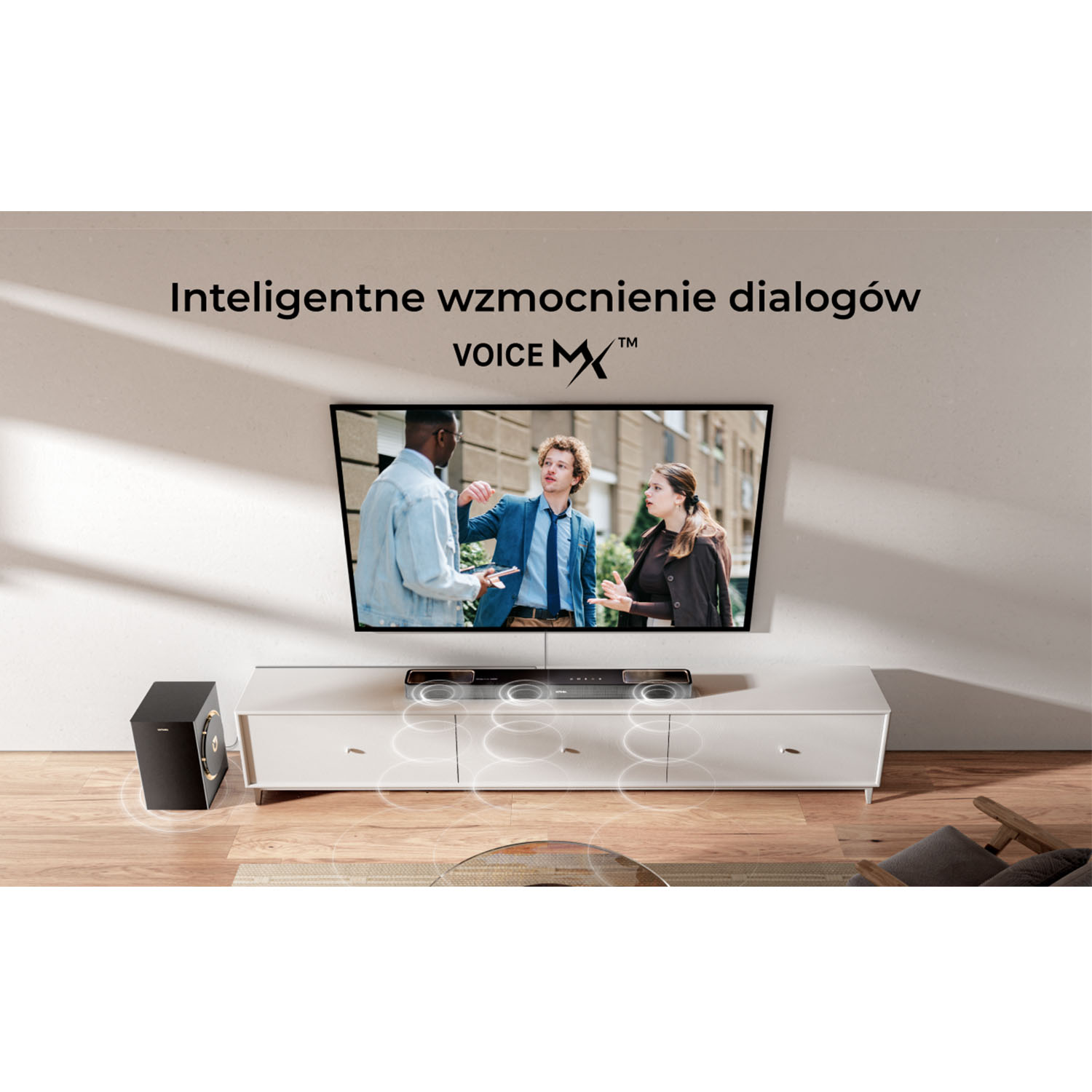 Telewizor znajduje się nad białą szafką. Na szafce znajduje się soundbar. Czarny subwoofer jest po lewej stronie.