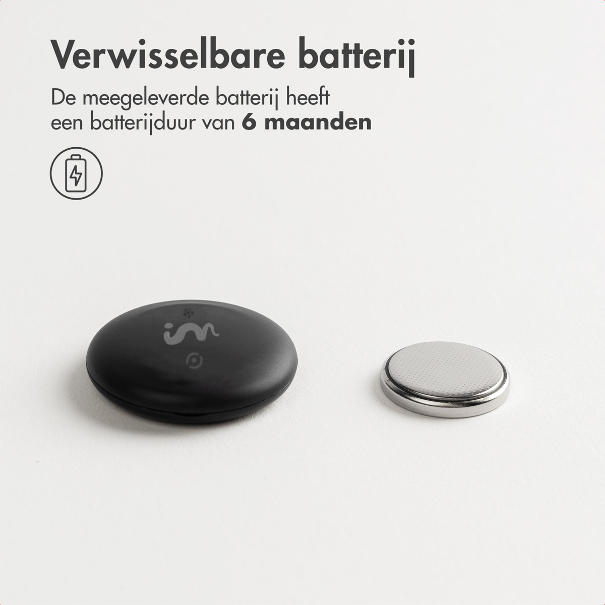 A black, round device next to a silver button battery. Text above states: replaceable battery, 6 months battery life.