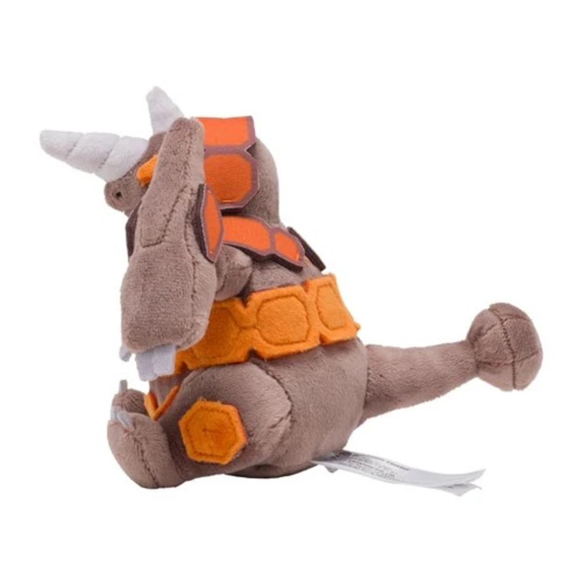Ein Plüschtier einer Zeichentrickfigur. Es ist braun mit orangefarbenen Akzenten und weißen Hörnern und Zähnen. Es sitzt mit einem Etikett.