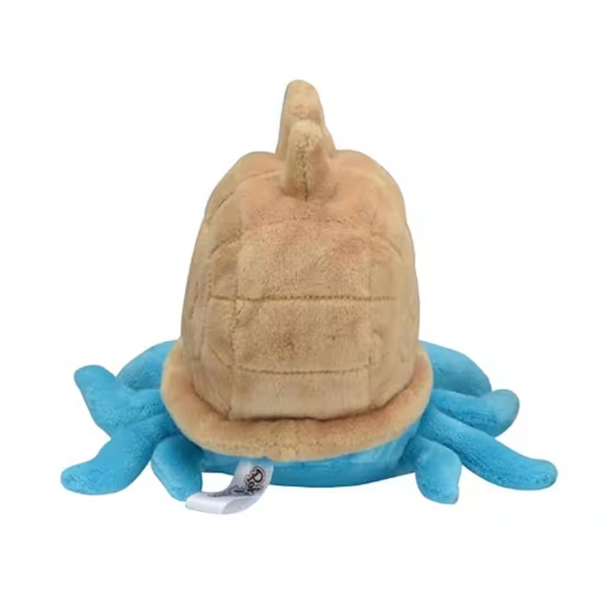 Ein Plüschtier in Form einer Schildkröte. Es hat einen beigefarbenen Panzer, blaue Tentakel und ein kleines Etikett. Der Hintergrund ist weiß.