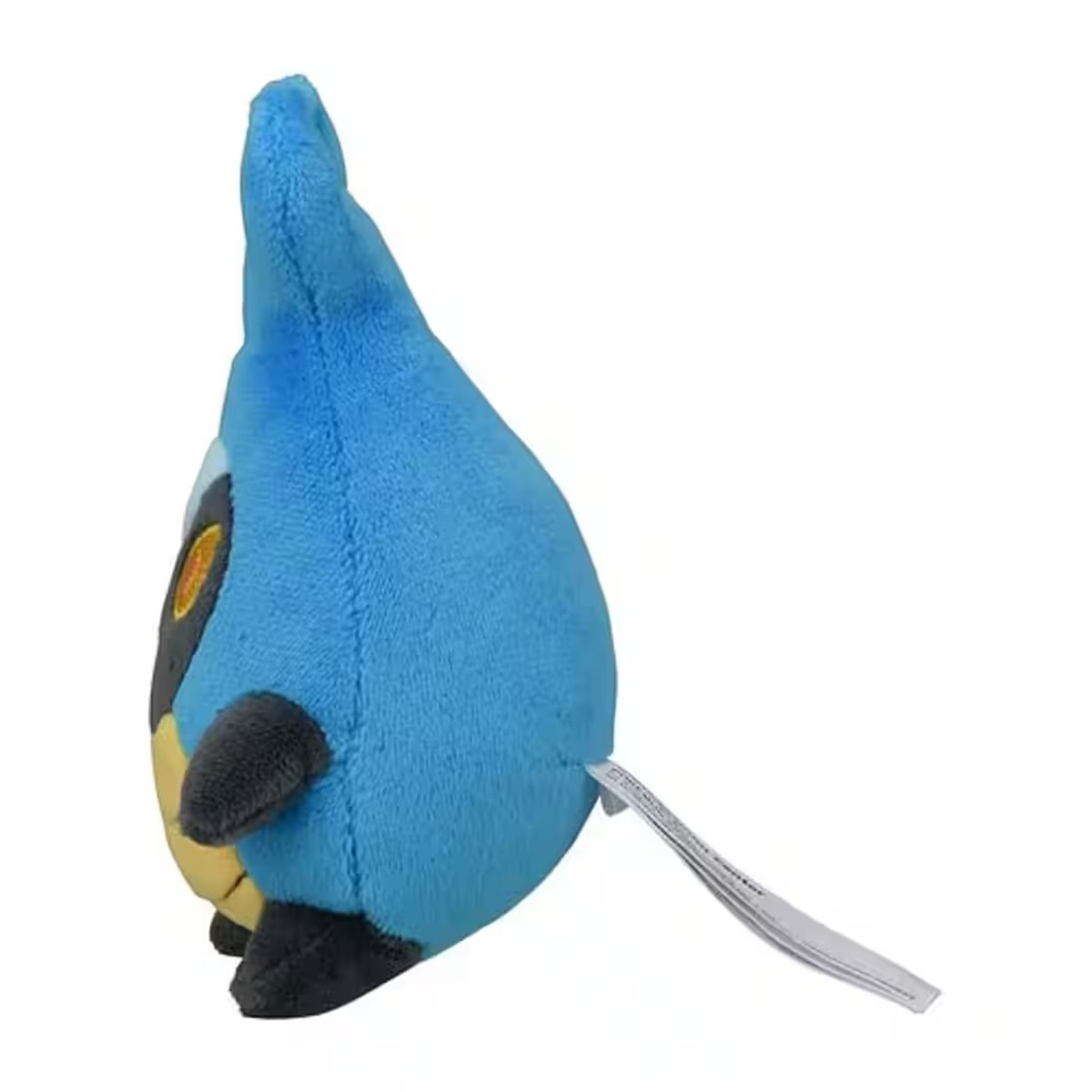 Ein Plüschtier einer blauen, tropfenförmigen Figur mit schwarzen und gelben Details. Es hat ein Etikett angebracht. Der Hintergrund ist weiß.