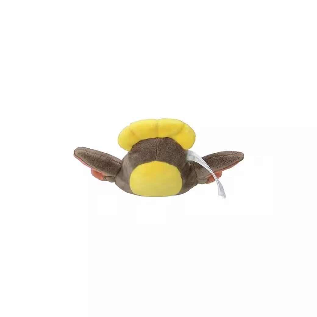 Ein Plüschtier in Form eines Vogels, mit gelben und braunen Farben, ausgebreiteten Flügeln und einem angebrachten Etikett.