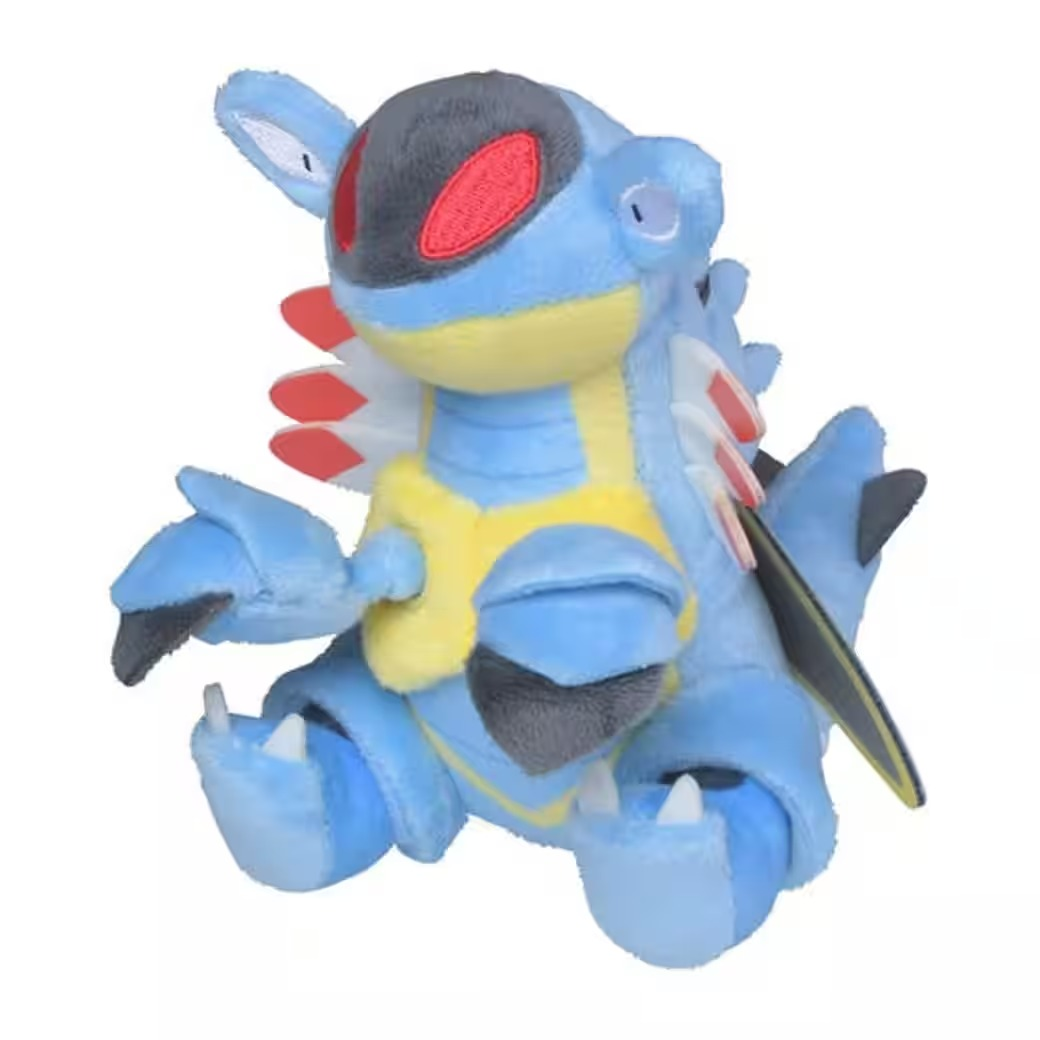 Ein blaues Plüschtier einer fiktiven Kreatur mit gelber Brust, roten Augen und weißen Zähnen vor weißem Hintergrund.