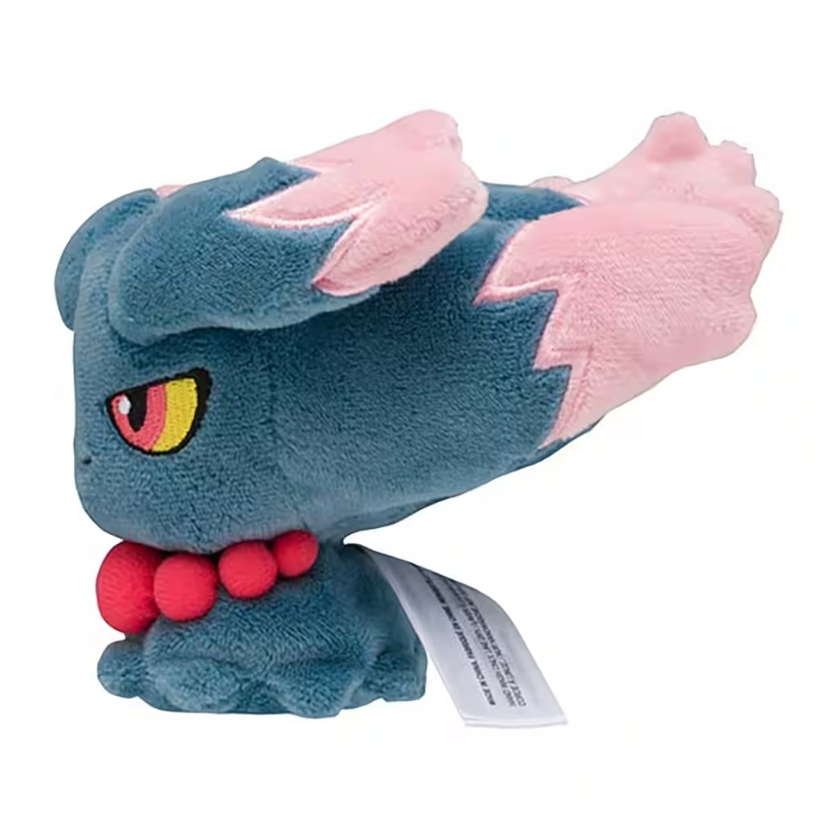 Ein Plüschtier eines blauen Wesens mit rosa Ohren und Akzenten. Es hat einen roten Kragen und gelbe Augen.