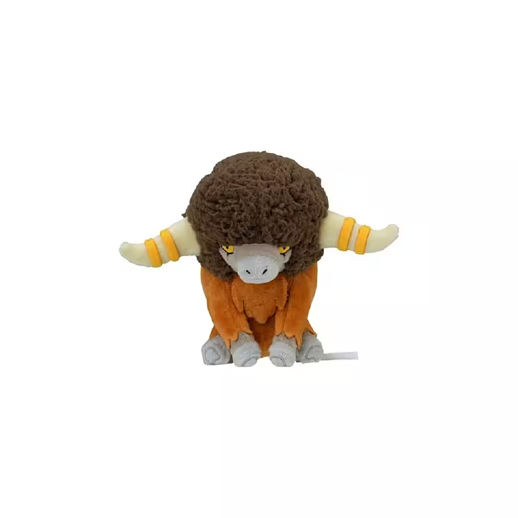 Ein Plüschtier eines braun-orangen, bullenartigen Wesens mit gelben Hörnern, das auf weißem Hintergrund sitzt.