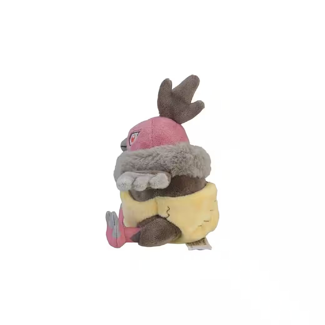 Ein Plüschtier eines Pokémon. Es hat einen rosa Kopf, einen braunen Körper, graues Fell und einen gelben, windelartigen Unterteil. Es sitzt auf einer weißen Oberfläche.