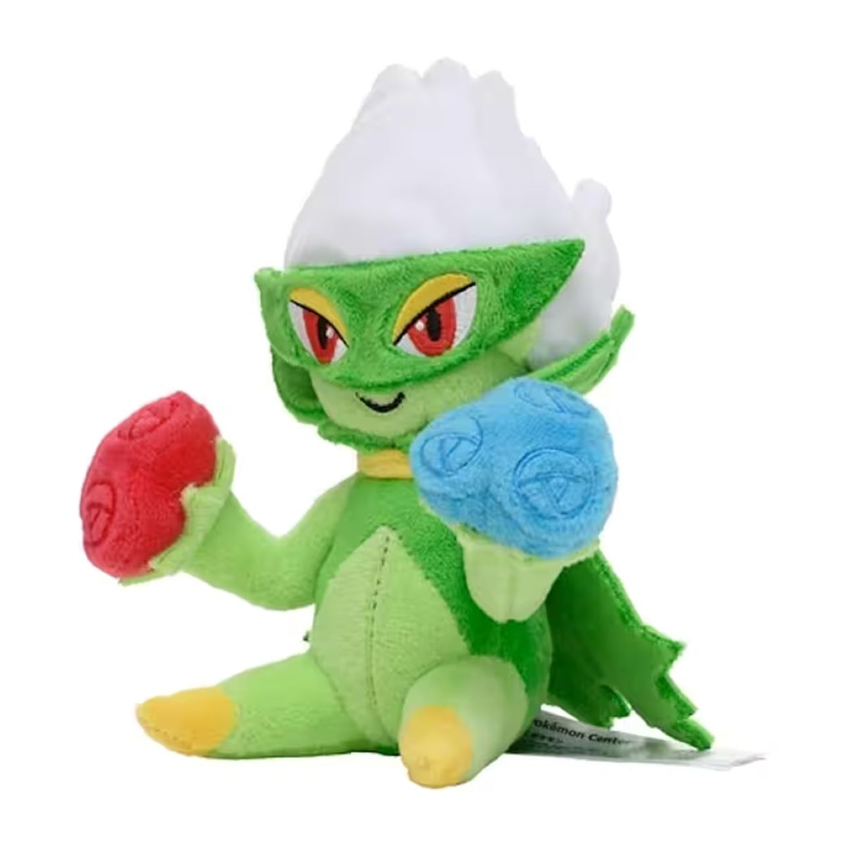 Eine grüne Plüschfigur mit weißem, blütenähnlichem Kopf, roten Augen, hält rote und blaue Gegenstände. Es ist ein Pokemon-Charakter.
