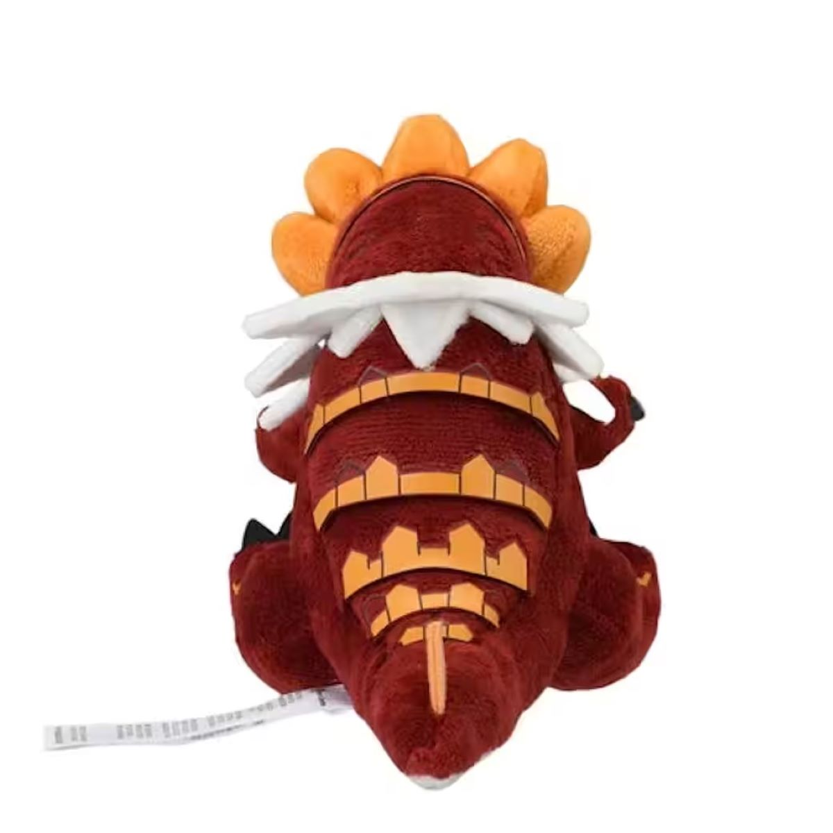 Ein rotes Plüschtier in Form eines Dinosauriers. Es hat orangefarbene Stacheln, einen weißen Kragen und orangefarbene Akzente. Das Spielzeug steht vor einem weißen Hintergrund.