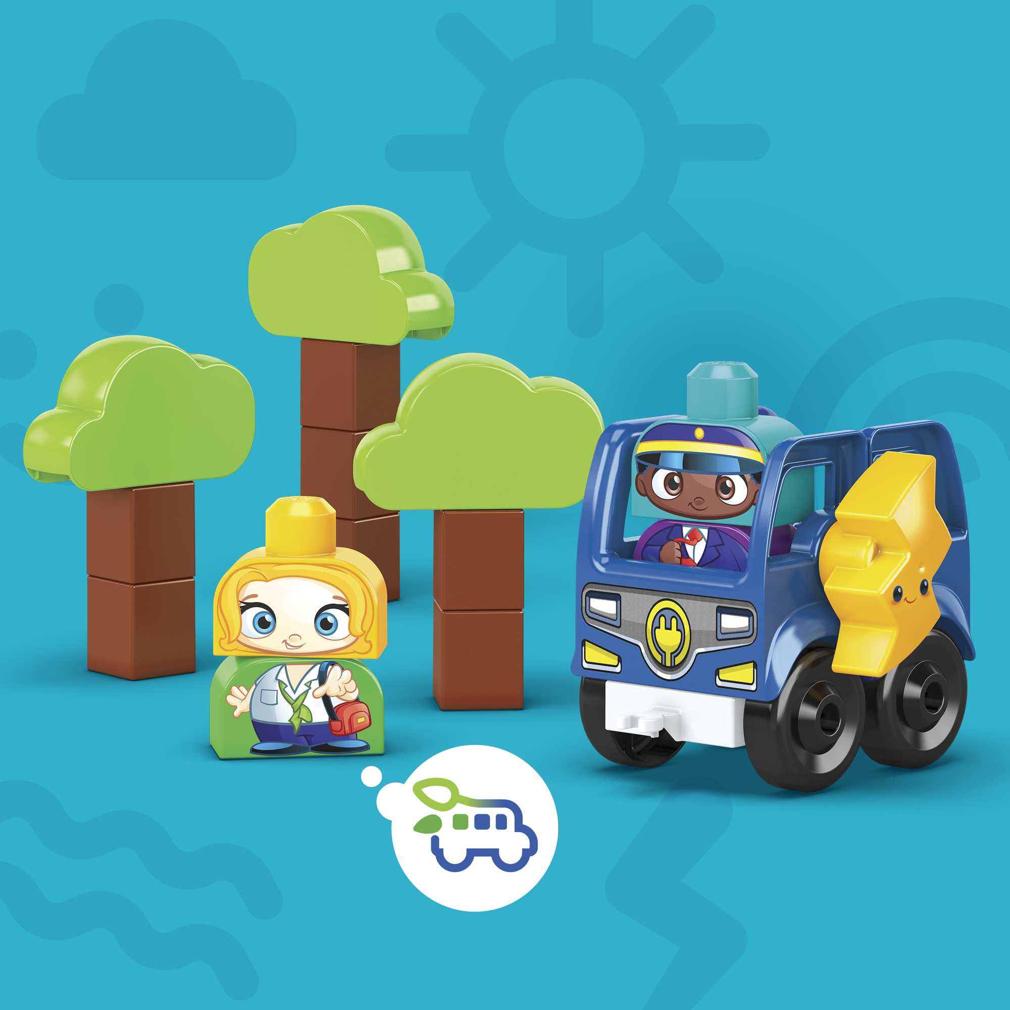 Scena z zabawkami z drzewami, autobusem szkolnym i dwiema postaciami. Autobus ma kierowcę. Tło jest niebieskie z elementami dekoracyjnymi.