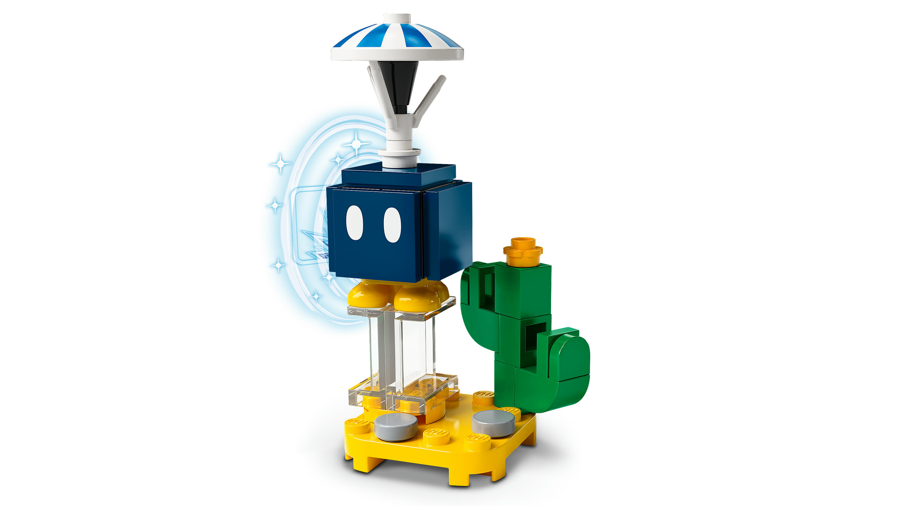 Lego yapımı yapı. Beyaz gözlü mavi bir blok, çizgili bir üst kısım ve yeşil bir kaktüs içerir. Sarı bir taban üzerinde.
