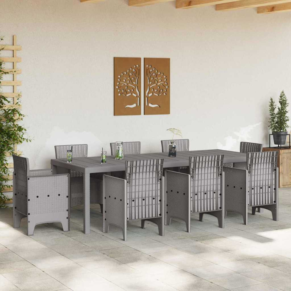 Essgruppe im Freien mit grauem Tisch und Stühlen. Wandkunst mit Bäumen. Pflanzen in Töpfen. Getränke auf dem Tisch, Terrasse.