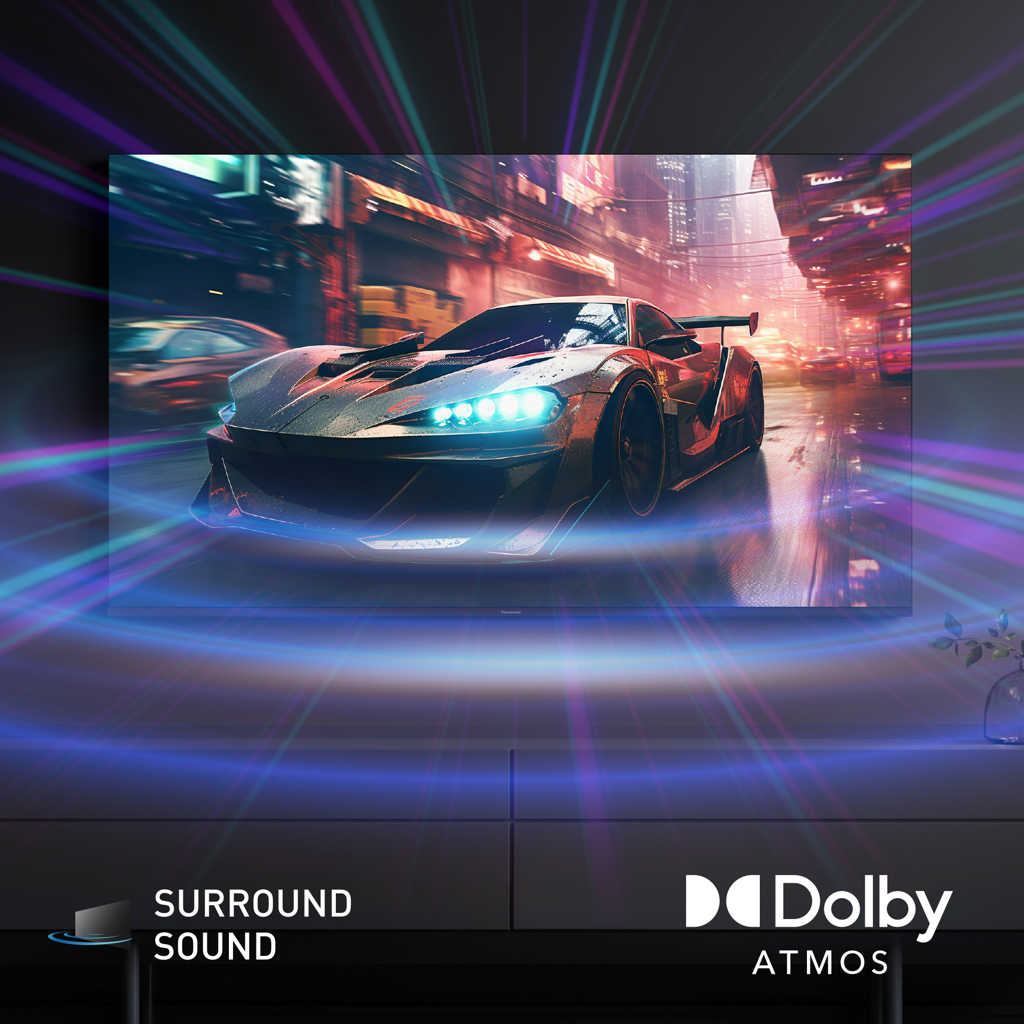 Samochód sportowy na mokrej drodze, wyświetlany na TV. Obecne światła i efekty rozmycia, z logo Dolby Atmos i Surround Sound.