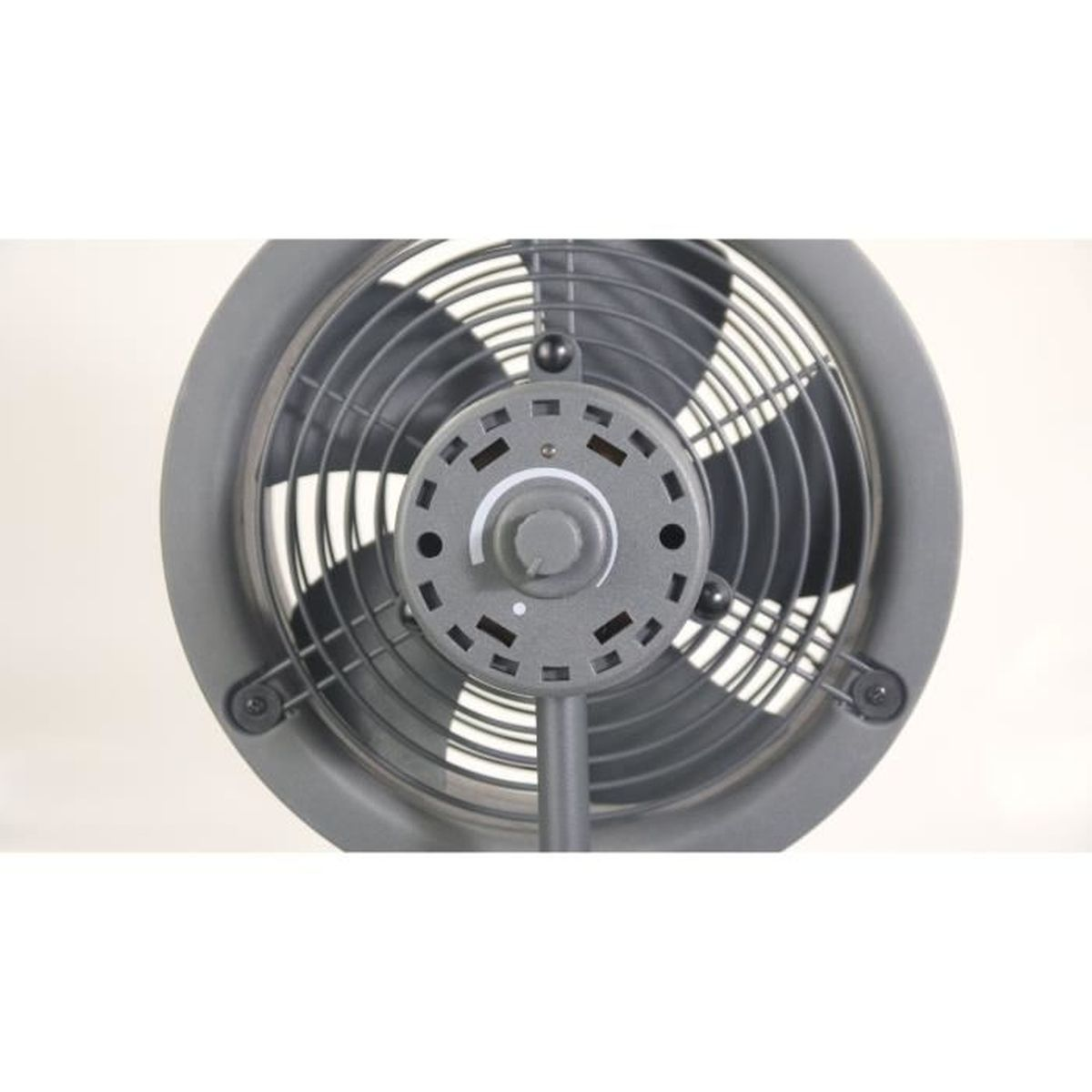A gray industrial fan, centered. The fan has a round cage, blades, and control dial. It is on a stand, against a white background.