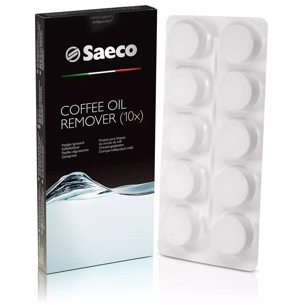 Una scatola di Saeco per la rimozione dell'olio di caffè e un blister di compresse bianche. La scatola è nera con testo bianco e il logo Saeco.