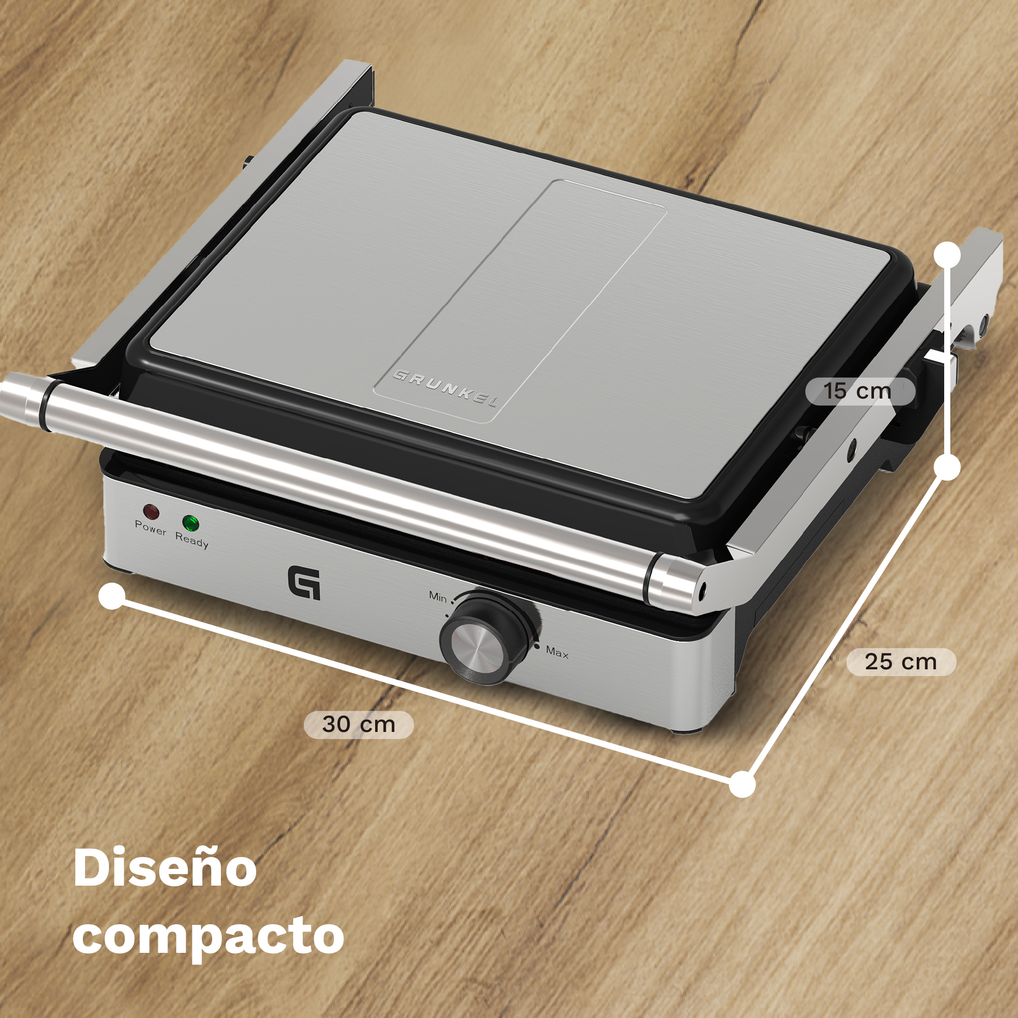 Una piastra per panini Grunkel argento e nera. Le dimensioni sono indicate. Le spie di alimentazione e pronto sono accese. Sfondo in legno.