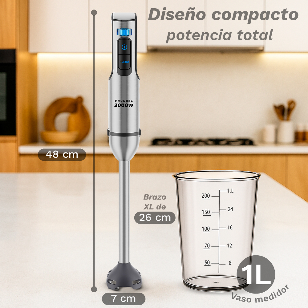 Una batidora de mano plateada y negra y un vaso medidor están sobre una encimera blanca. La batidora mide 48 cm de alto. La taza está marcada hasta 1L.
