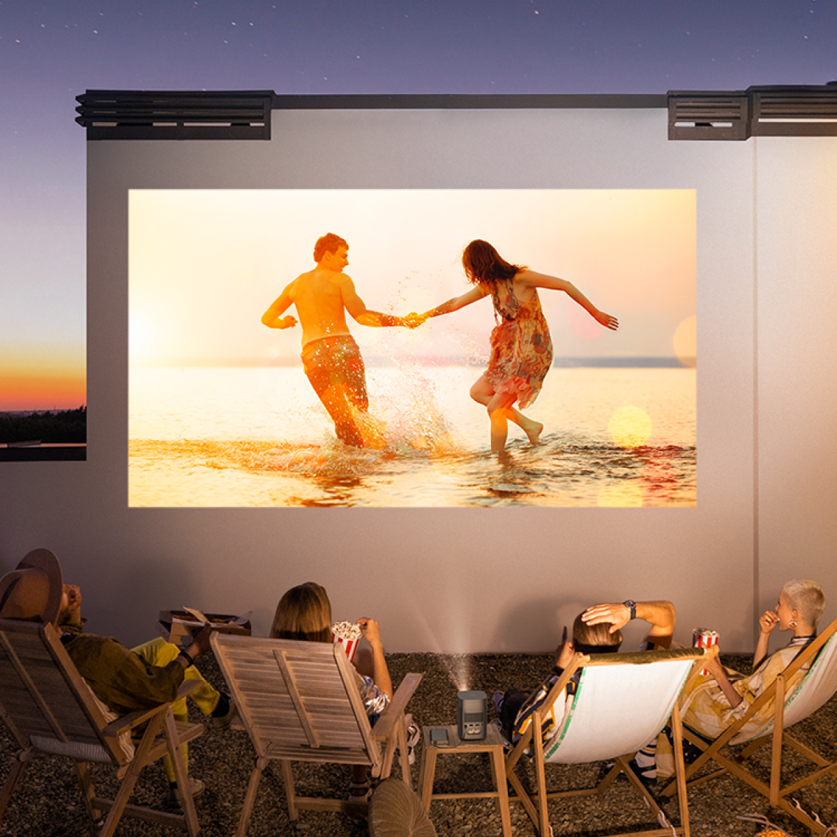 People watching a movie projected on a wall. The movie shows a couple in the water. People are sitting in chairs, enjoying the show.