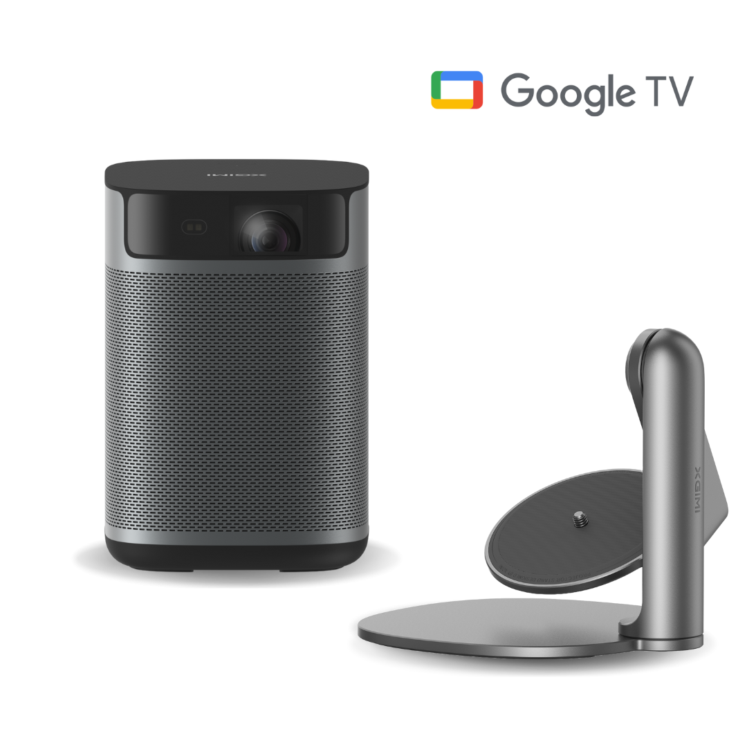 A projector with a stand. The projector is cylindrical with a speaker mesh. The stand is silver with a round base. Google TV logo.