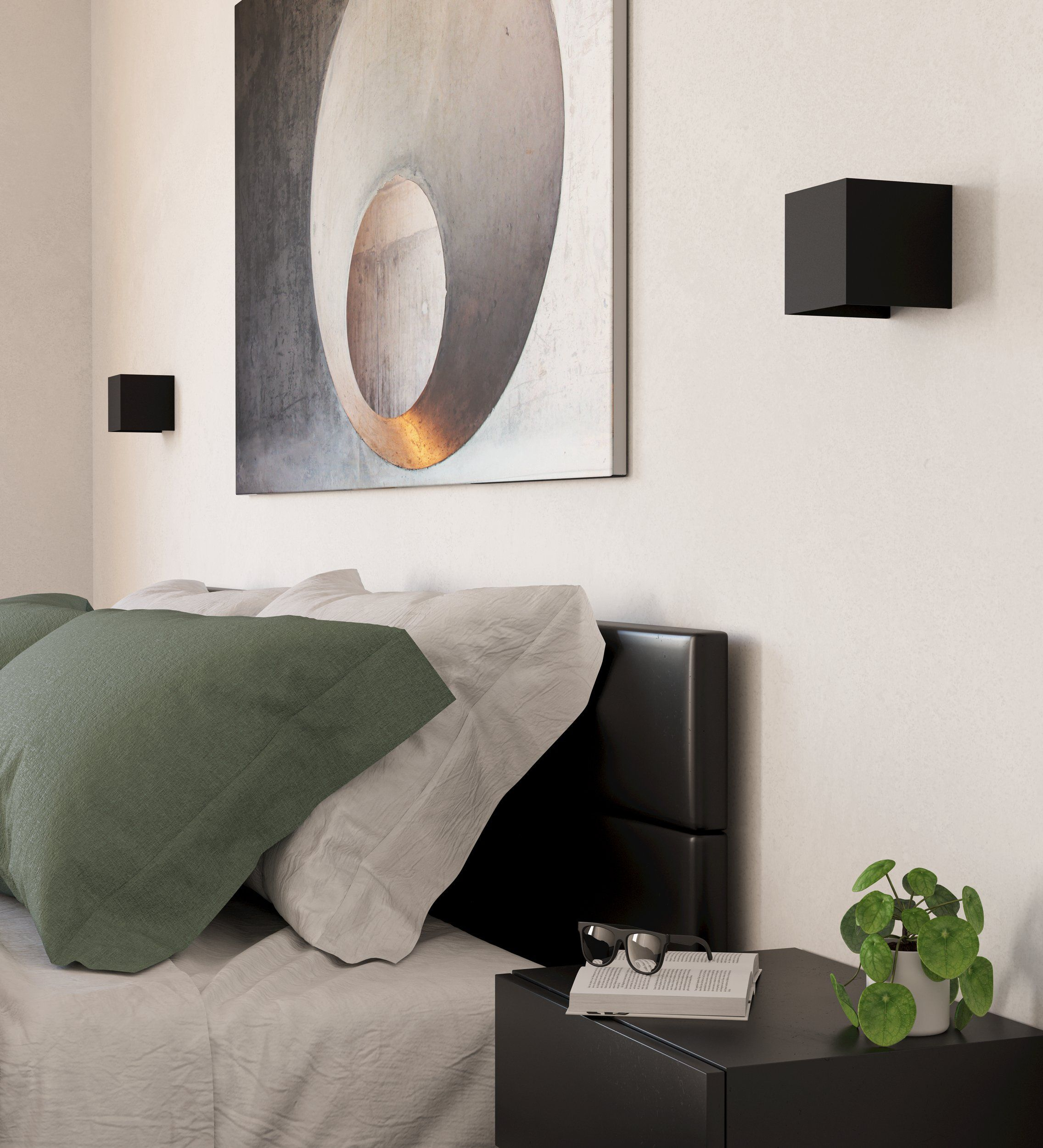 Chambre avec lit, oreillers, art et une table de chevet. Une plante et un livre sont sur la table.