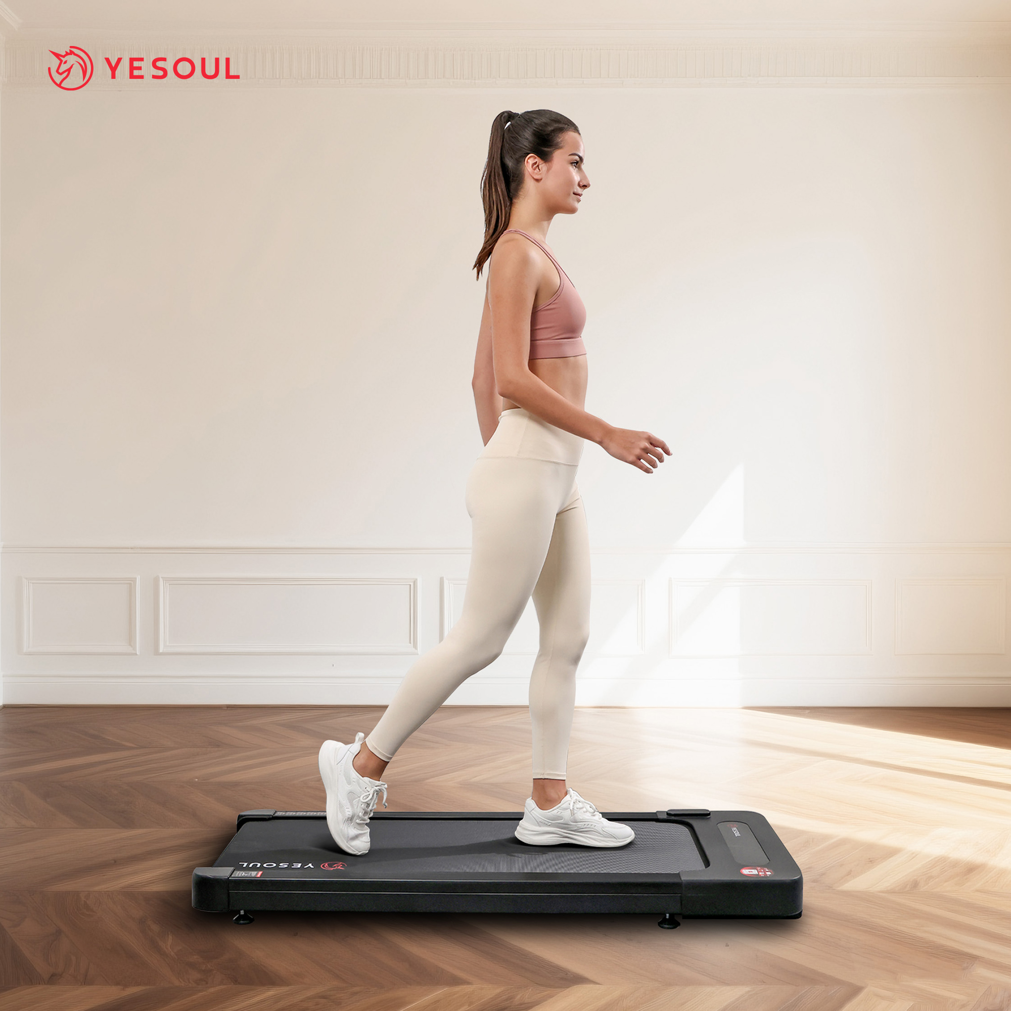 Eine Frau geht auf einem schwarzen Laufband. Sie trägt Sportkleidung und weiße Schuhe. Der Hintergrund ist eine helle Wand und ein Holzboden.