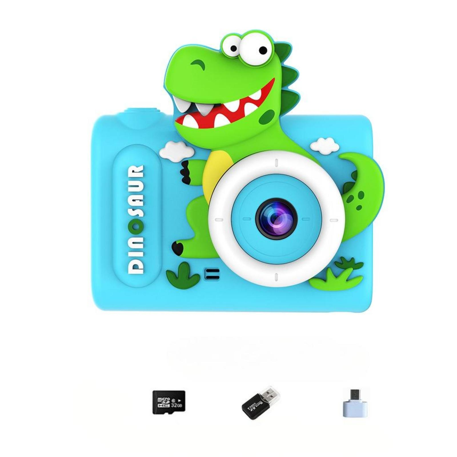 Eine blaue Kamera in Dinosaurierform mit einem grünen Dinosaurier oben drauf. Zubehör umfasst eine Speicherkarte, einen USB-Adapter und einen Kartenleser.
