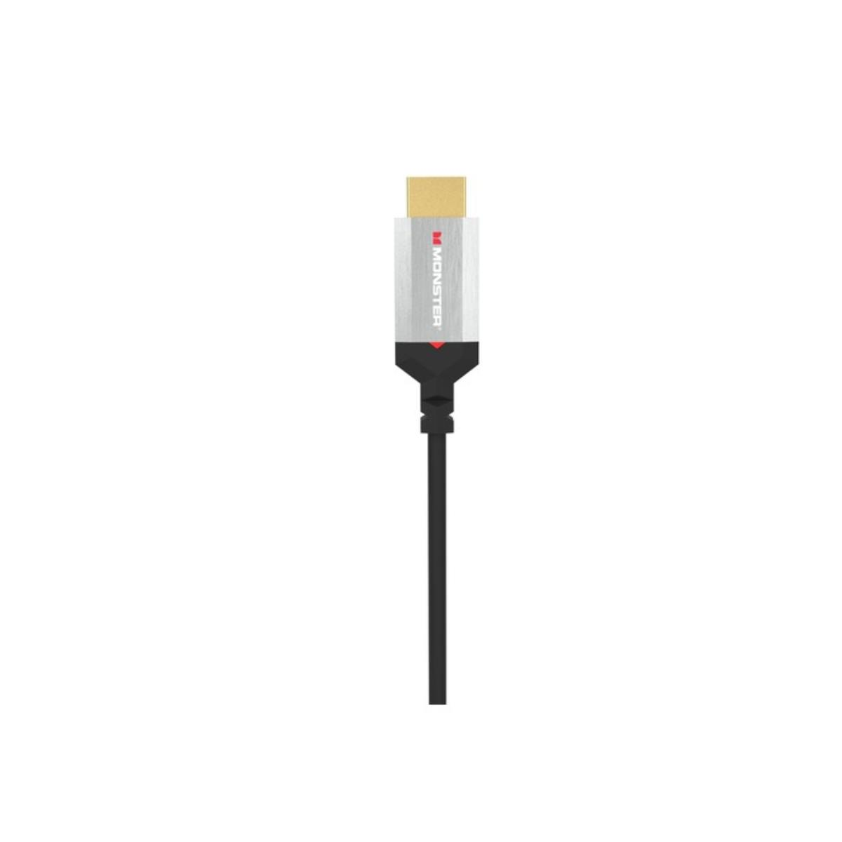 Un cavo HDMI su sfondo bianco. Il cavo ha un connettore dorato, una sezione centrale argentata con 'MONSTER' e un cavo nero.