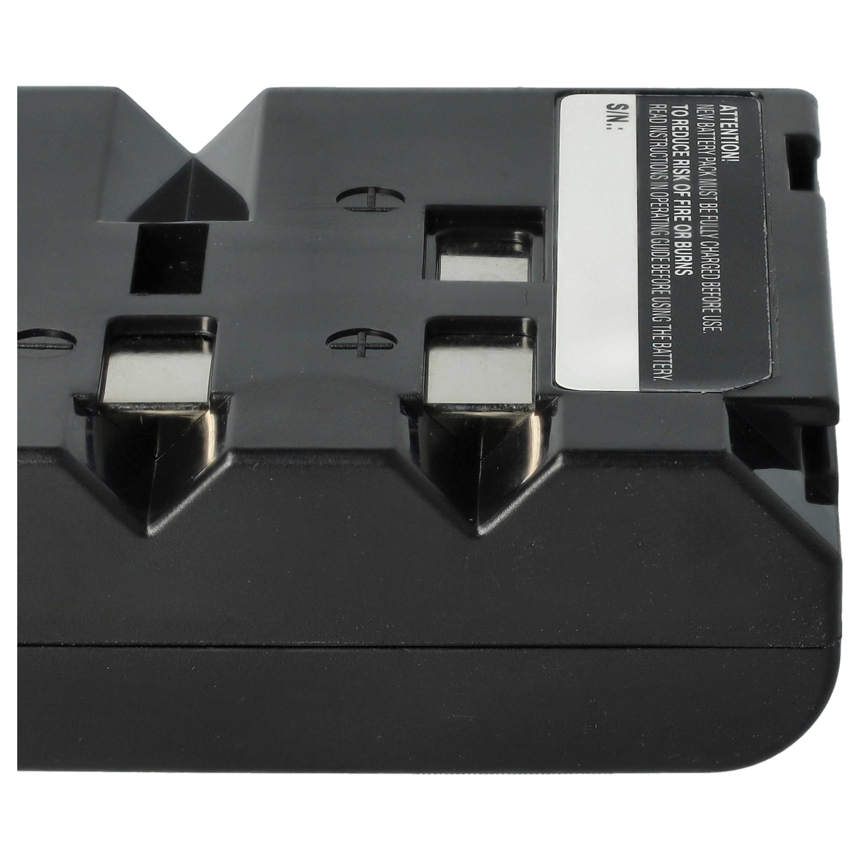 Ein schwarzes Batterieladegerät mit silbernen Kontakten. Text auf einem weißen Etikett warnt vor der Verwendung der Batterie.