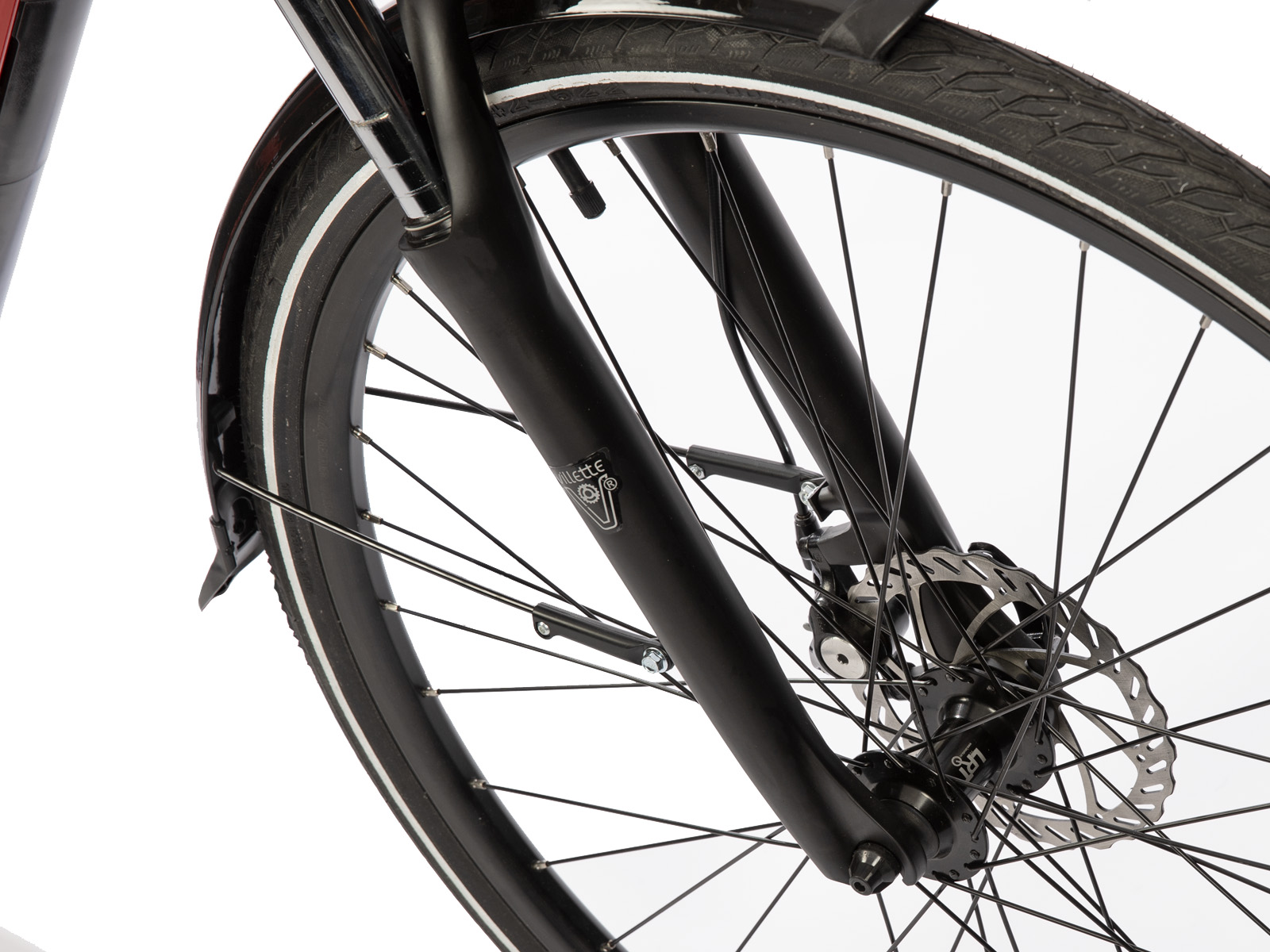 Close-up van het voorwiel van een fiets. Zwarte band, spatbord en vork. Zilveren spaken en schijfrem. Witte achtergrond.
