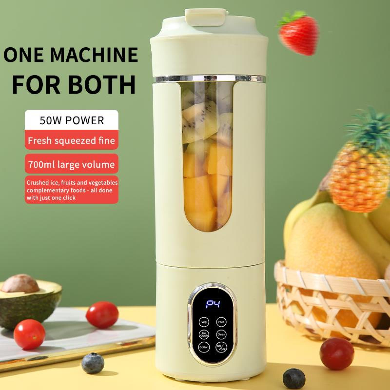 Ein Mixer mit Obst im Inneren. Erdbeere und Ananas. Tomaten, Avocado und Blaubeeren. Grüner Hintergrund und gelbe Oberfläche.