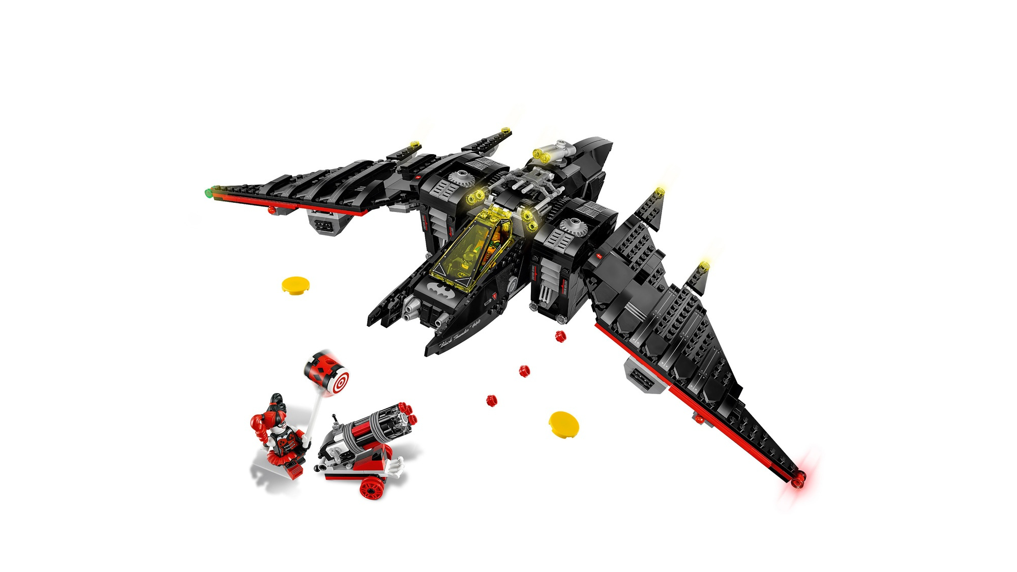 Een Lego Batwing-vliegtuig met rode en zwarte details, met Harley Quinn en een kanon op de grond, en enkele gele ronde stukken.