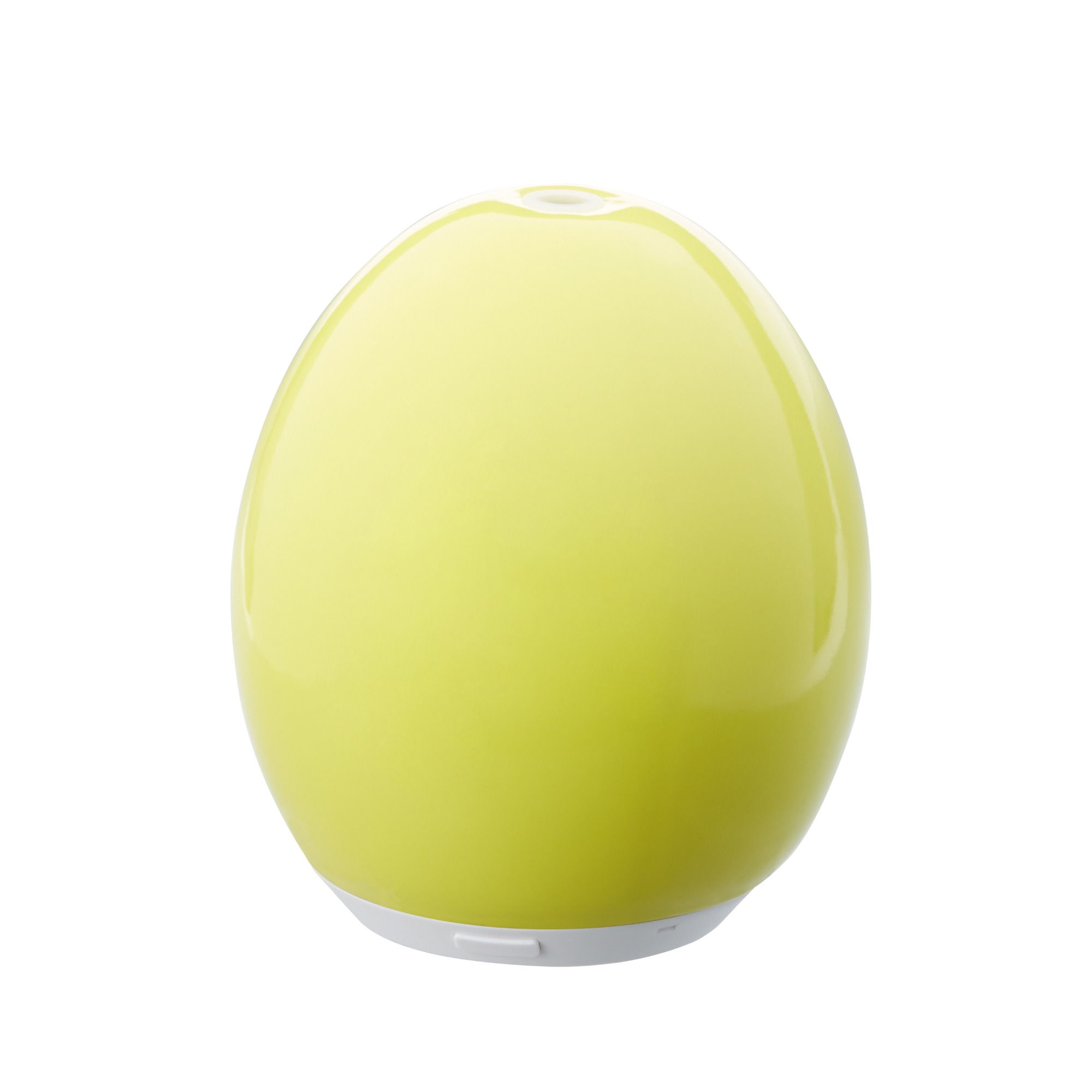 Un diffuseur d'huiles essentielles vert clair en forme d'œuf est posé sur une surface blanche. Il a une petite ouverture en haut et une base blanche.
