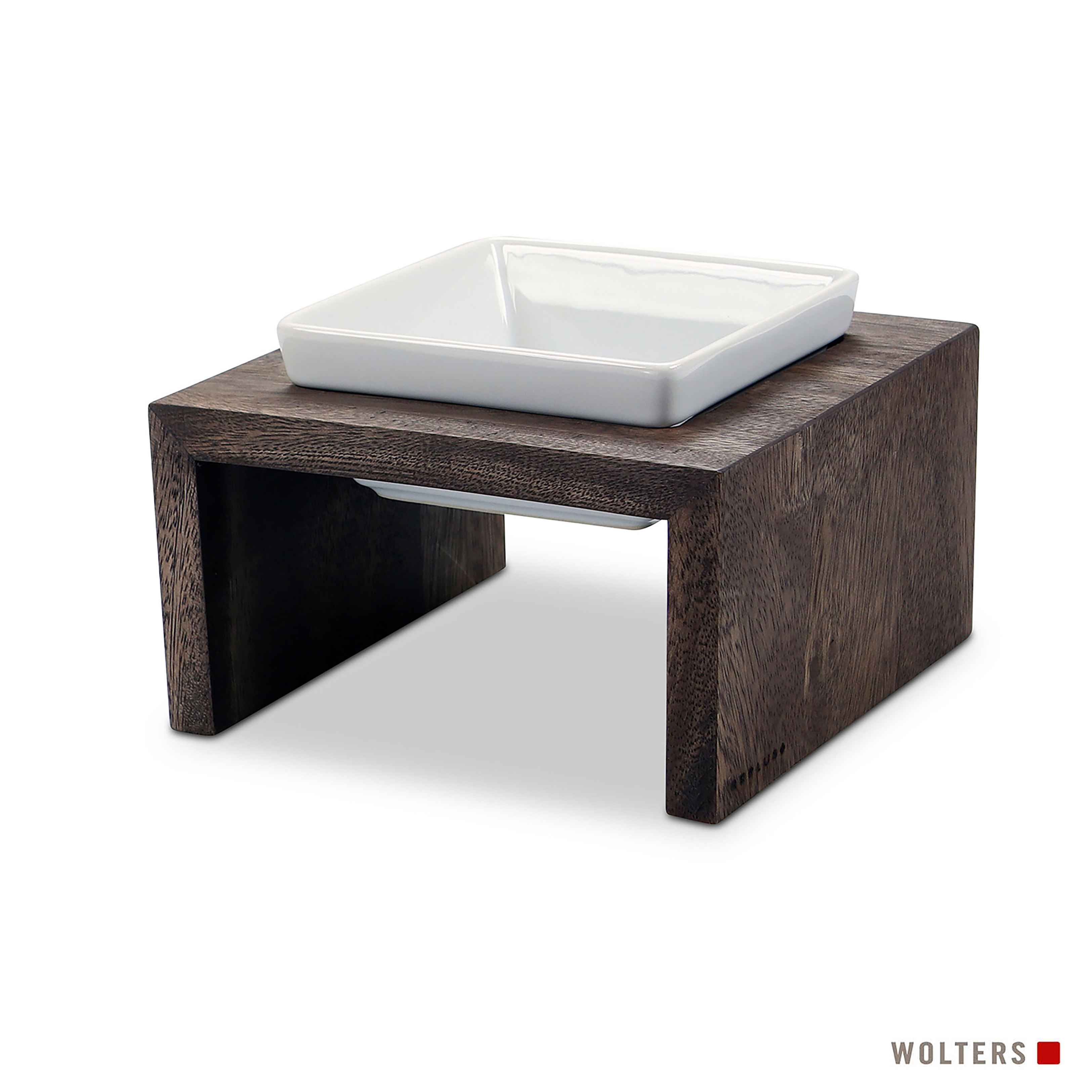 Eine weiße, quadratische Schüssel steht auf einem dunklen Holzständer. Der Ständer hat eine rechteckige Basis.
