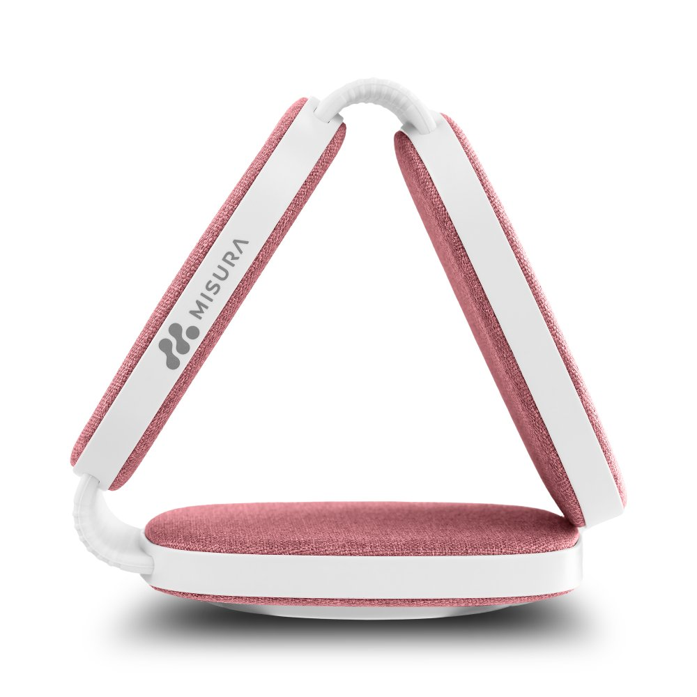 Różowo-białe urządzenie Misura złożone w trójkąt. Ma różową powierzchnię z tkaniny i białą ramkę. Widoczne jest logo.