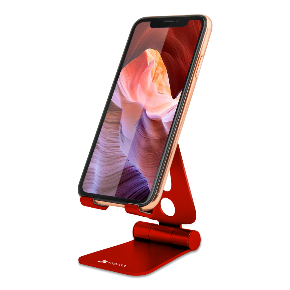 Uno smartphone è su un supporto rosso. Il telefono mostra un'immagine del paesaggio. Il supporto ha un design pieghevole e un logo 'NISURA'.