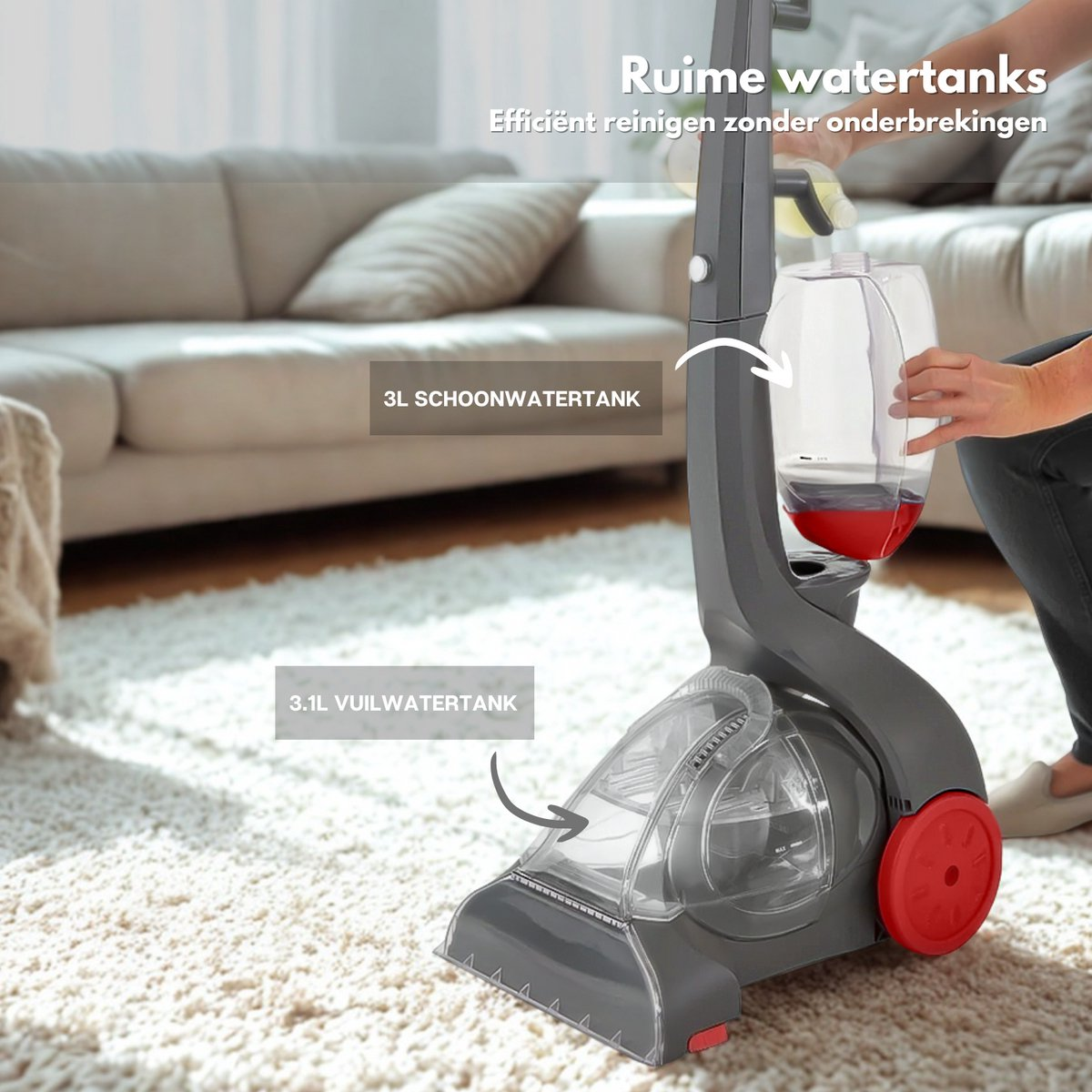 A carpet cleaner with water tanks is shown. A person is holding the water tank, with a red wheel on the cleaner. A sofa is in the background.