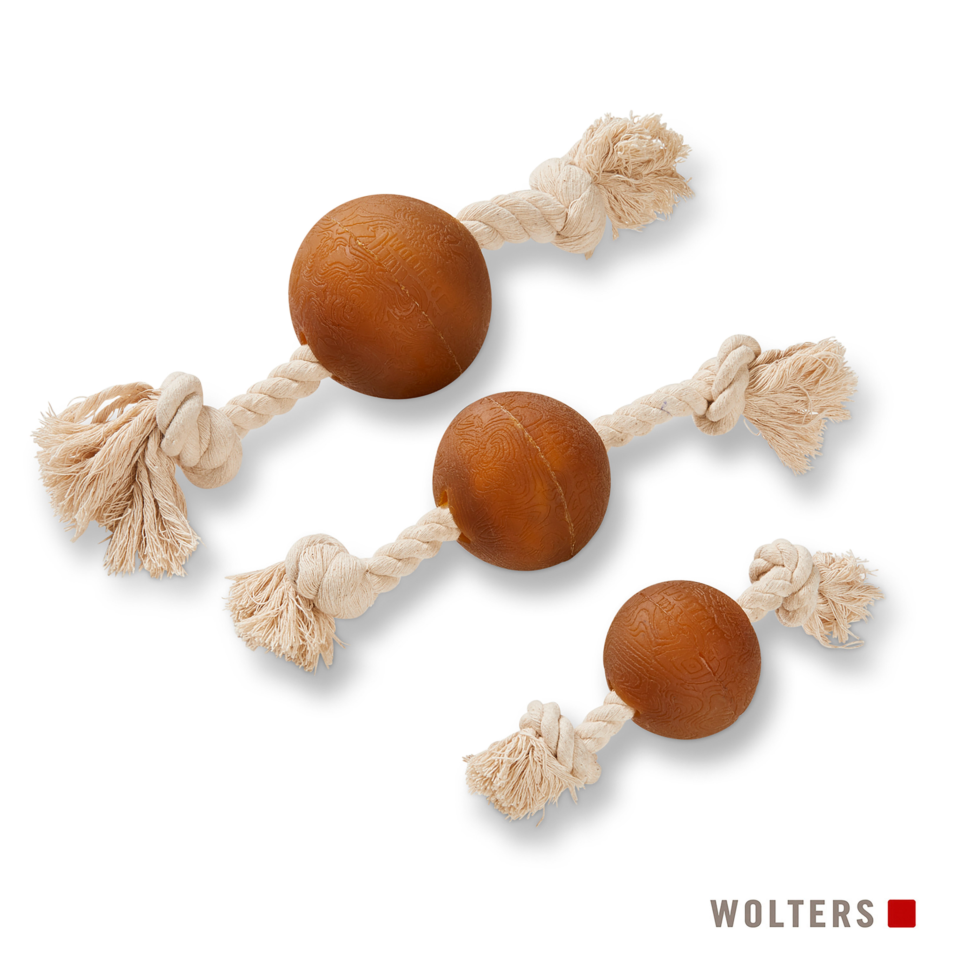 Drei Hundespielzeuge mit braunen Bällen und beigen Seilen auf weißem Hintergrund. Wolters-Logo unten.