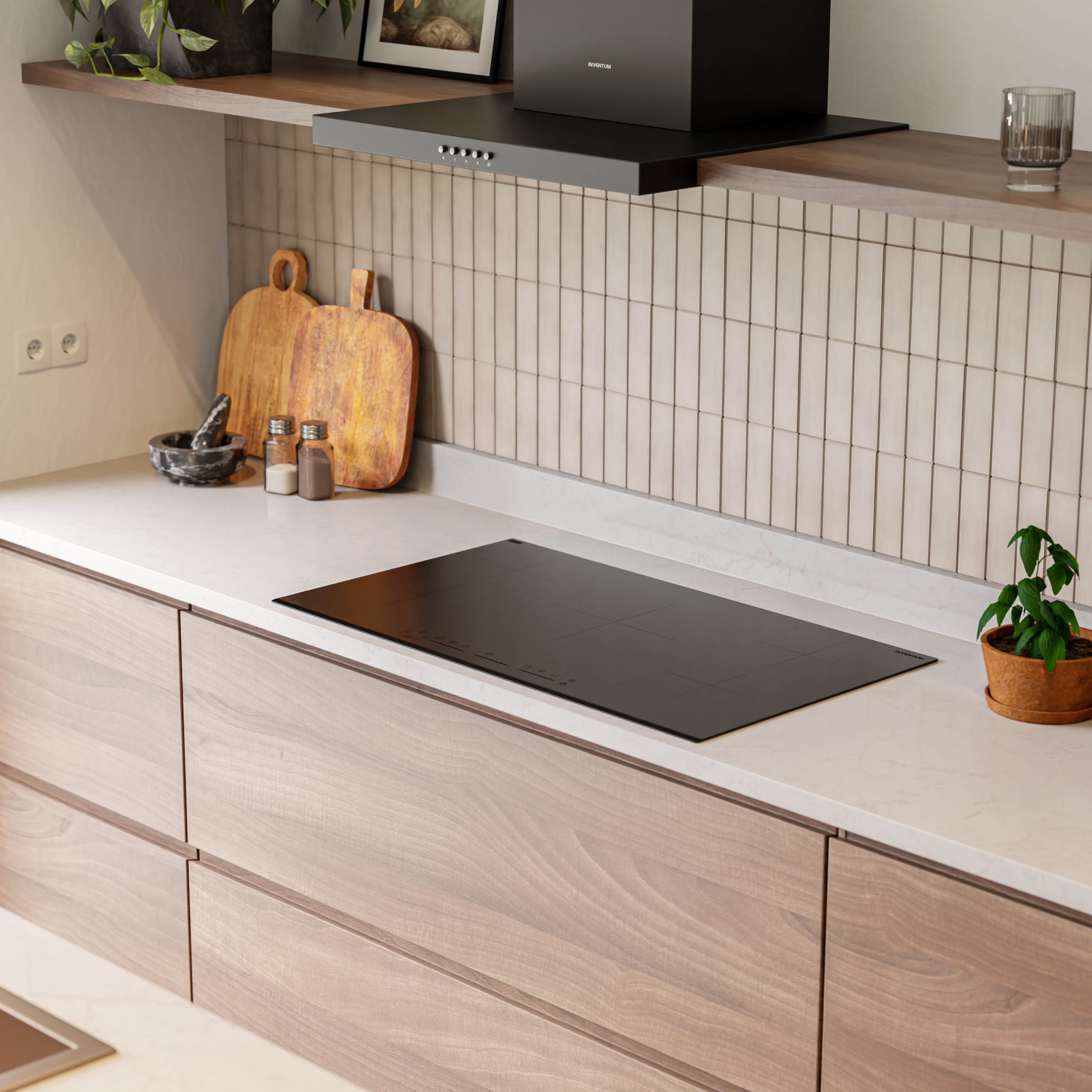 A modern kitchen with wooden cabinets, a black stovetop, and a white countertop. There are plants and kitchen tools on the counter.