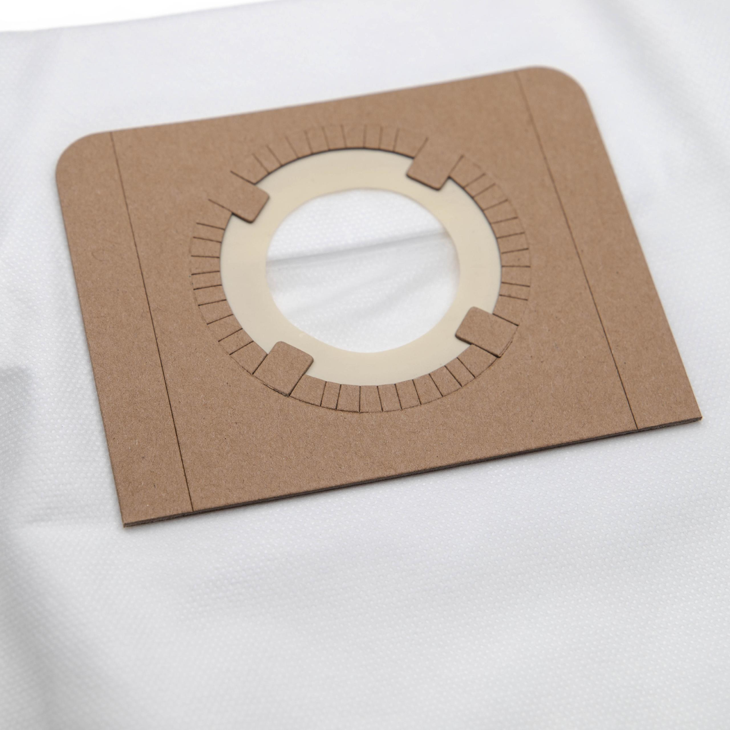 Ein brauner Pappfilter mit einer zentralen Öffnung liegt auf weißem Stoff. Der Filter hat eine kreisförmige Öffnung.