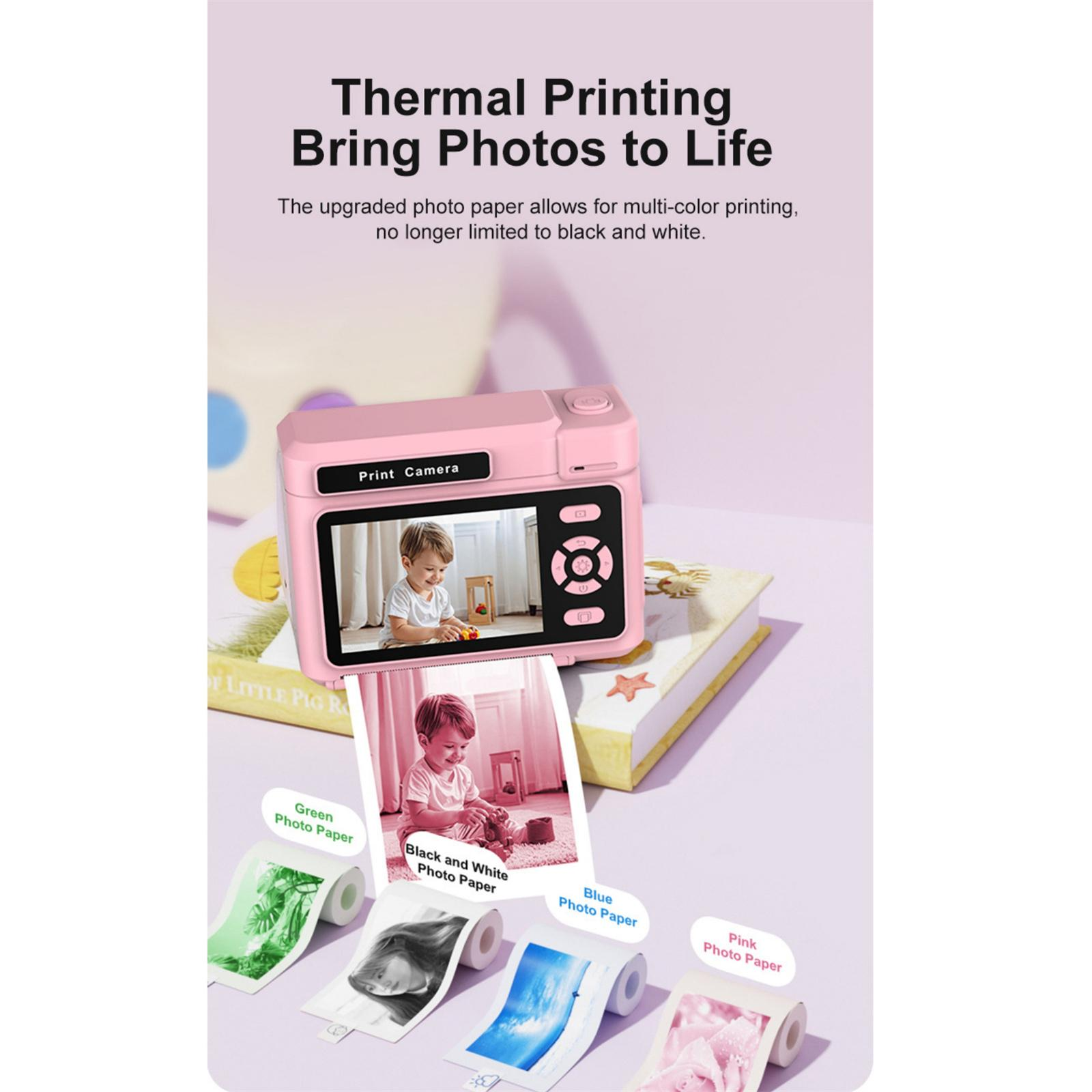 Rosa Druckerkamera mit einem Foto eines Kindes, Rollen mit Farbphotopapier und Text über Thermodruck.