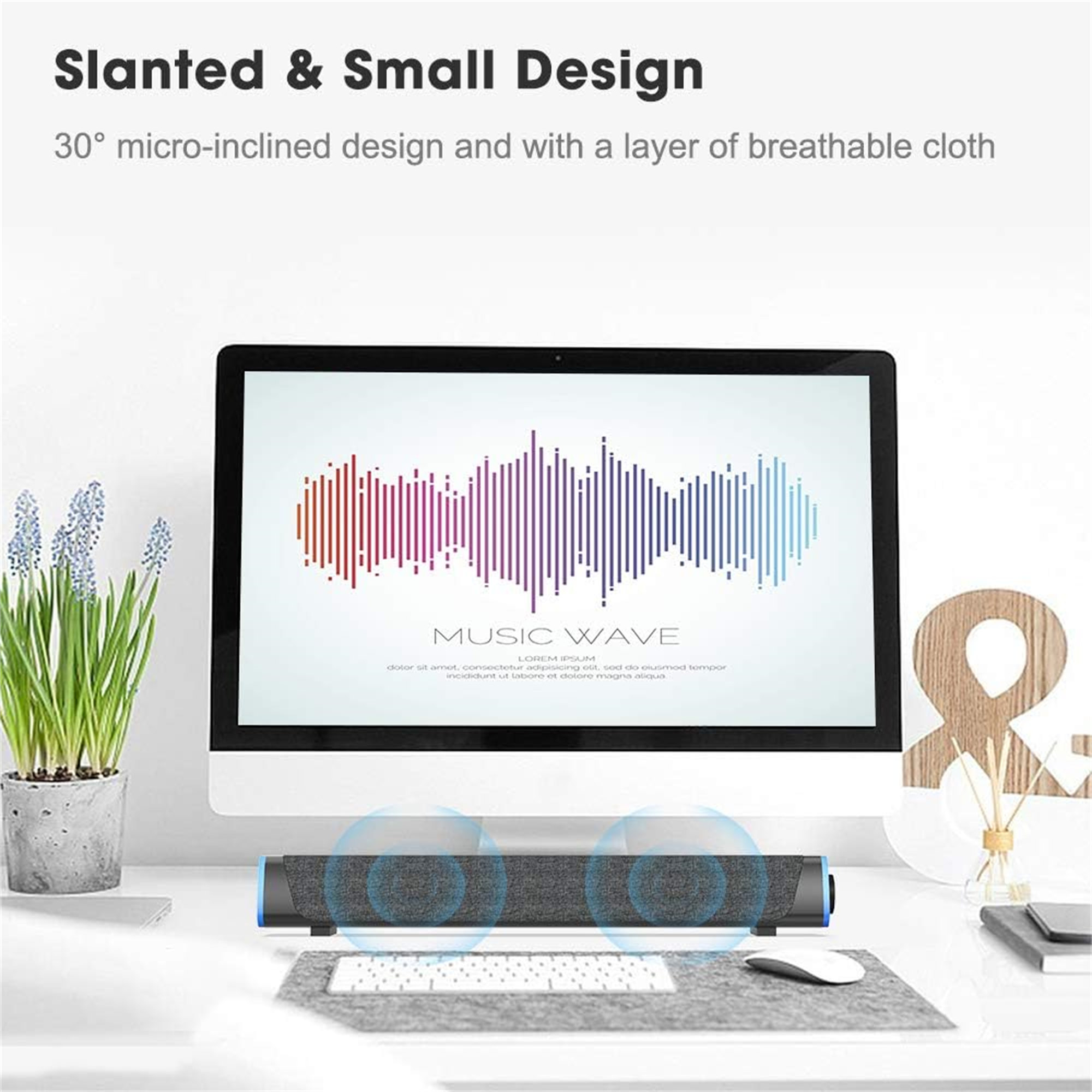 Ein Computermonitor zeigt ein Musikwellendesign. Darunter befindet sich ein Lautsprecher. Eine Pflanze, eine Tastatur und eine Maus sind ebenfalls vorhanden.