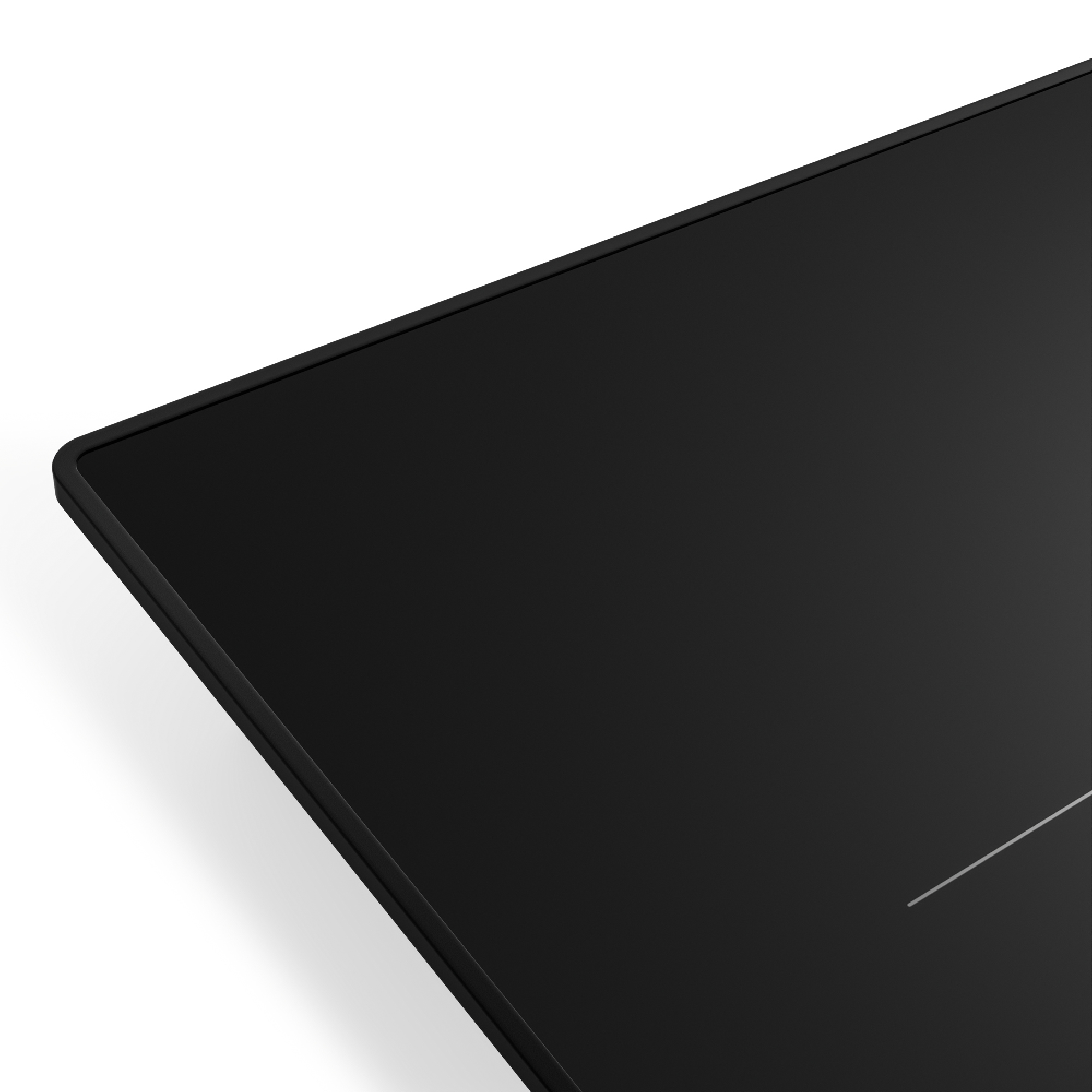 Primer plano de una placa de inducción negra y rectangular. Se ve la esquina, con fondo blanco y una línea blanca.
